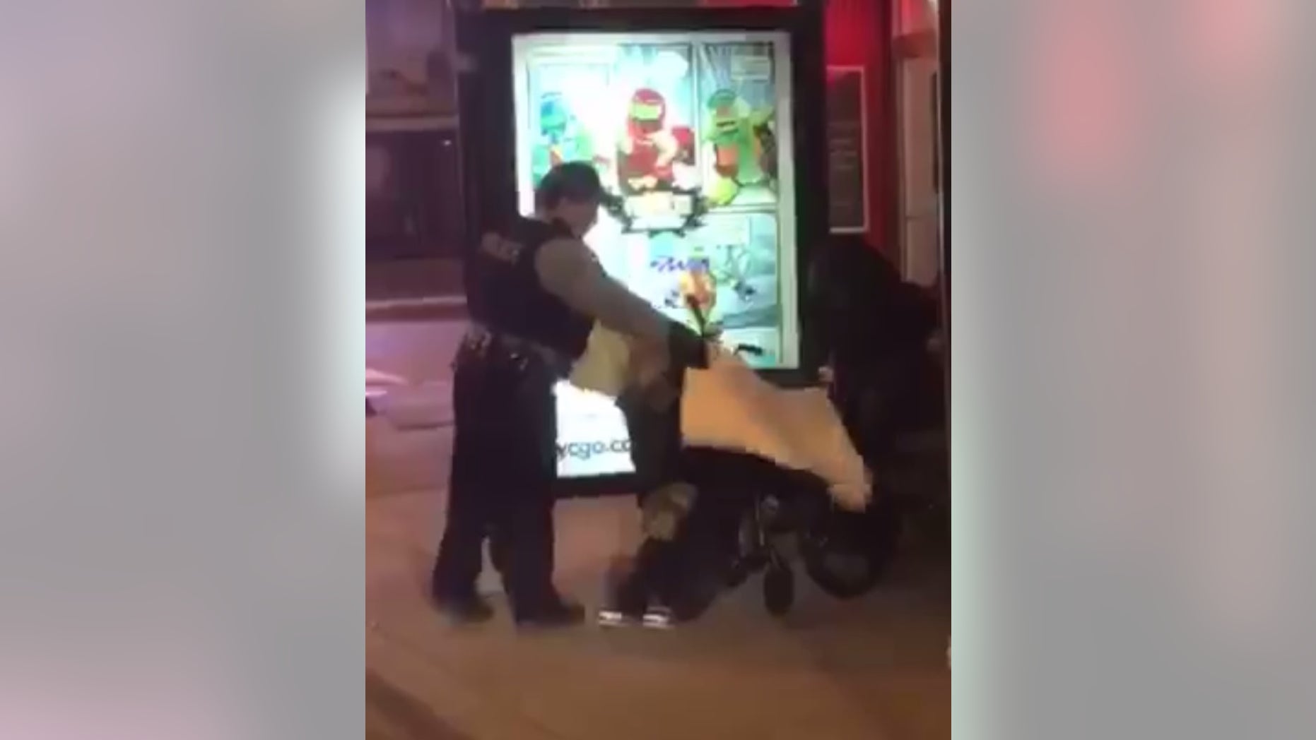 Officer Velazquez giving the woman a blanket.