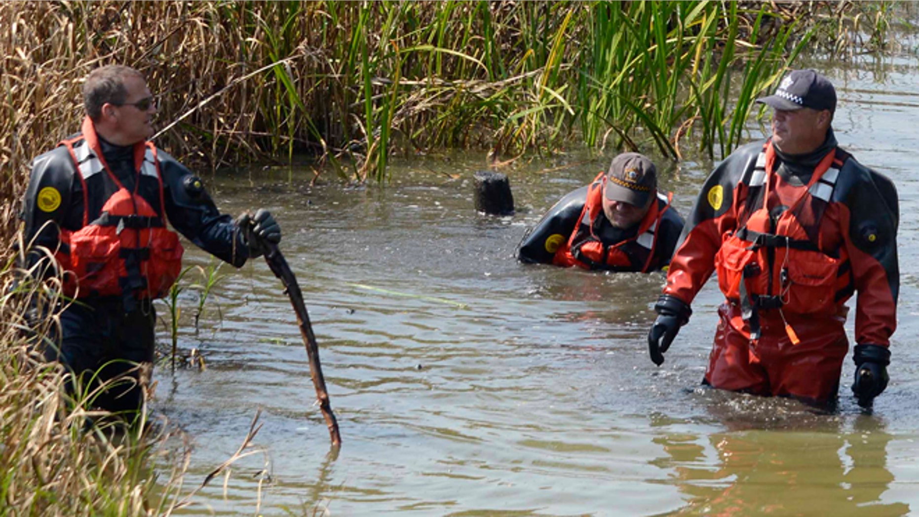 Sept. 6, 2015: Chicago Police Marine Unit divers search a lagoon at Garfield Park, in Chicago, where a toddler's decomposed head, feet and hand were found.