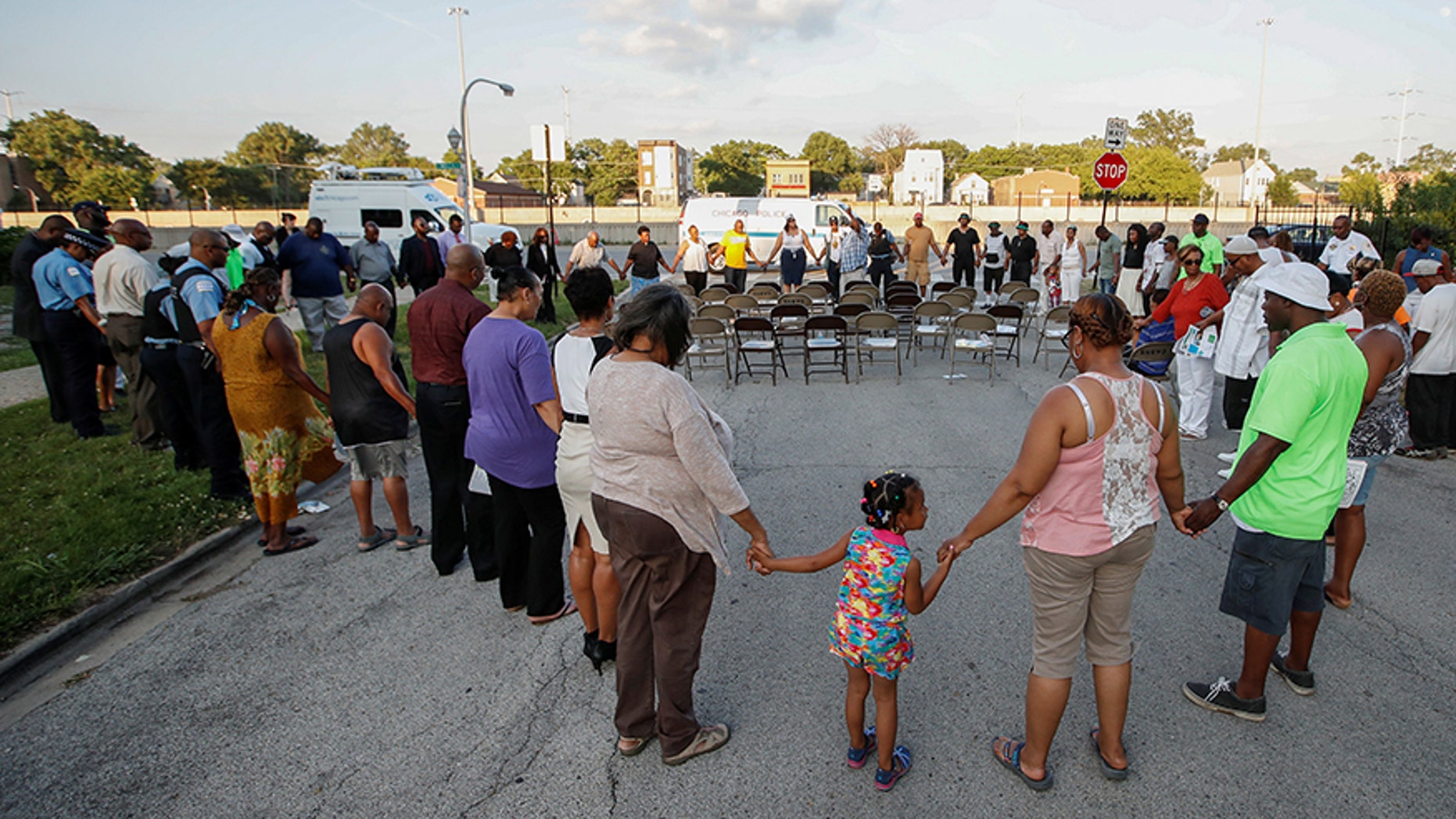 Chicago Police officers and community members gather in a prayer during a rally supporting efforts to stop violence in Chicago in July 2017.