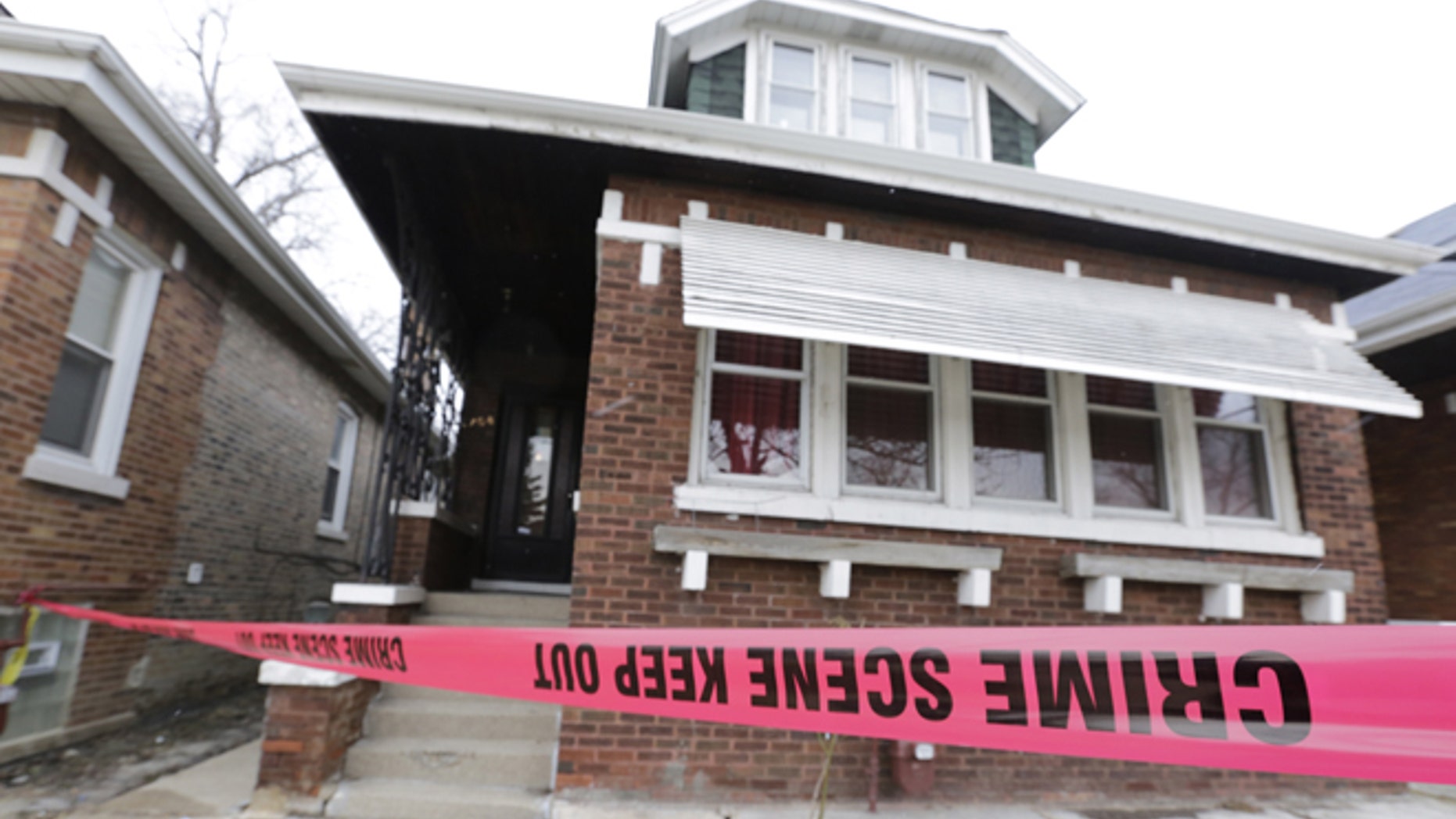 Feb. 5, 2016,: Crime scene tape surrounds a home in Chicago. (AP Photo/M. Spencer Green)