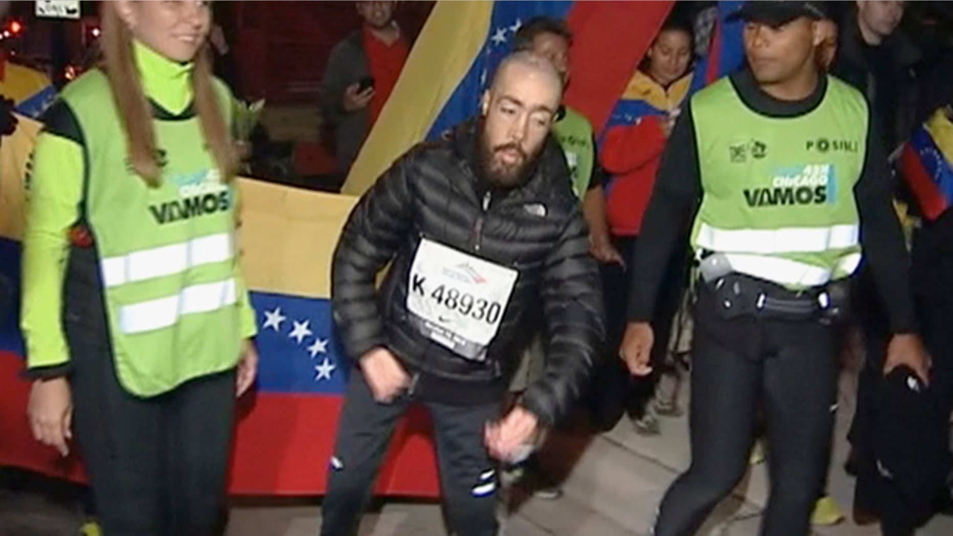 Oct. 14, 2013: Maickel Melamed, 38, center, of Venezuela, who has muscular dystrophy, nears the finish line to be the last runner to finish the Chicago Marathon.