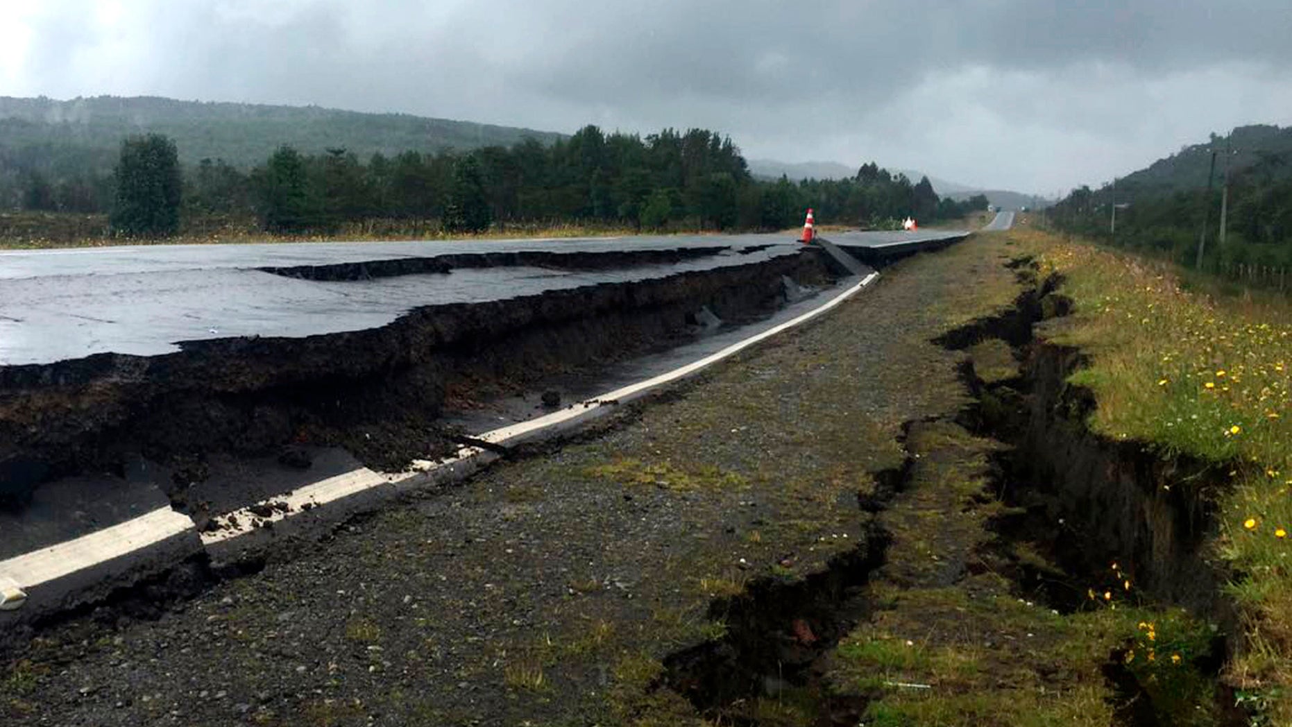 Cracks appear in and along a road near Quellon, Chile, Sunday, Dec. 25, 2016, after an earthquake. (Edinson Capdevilla/Aton via AP)