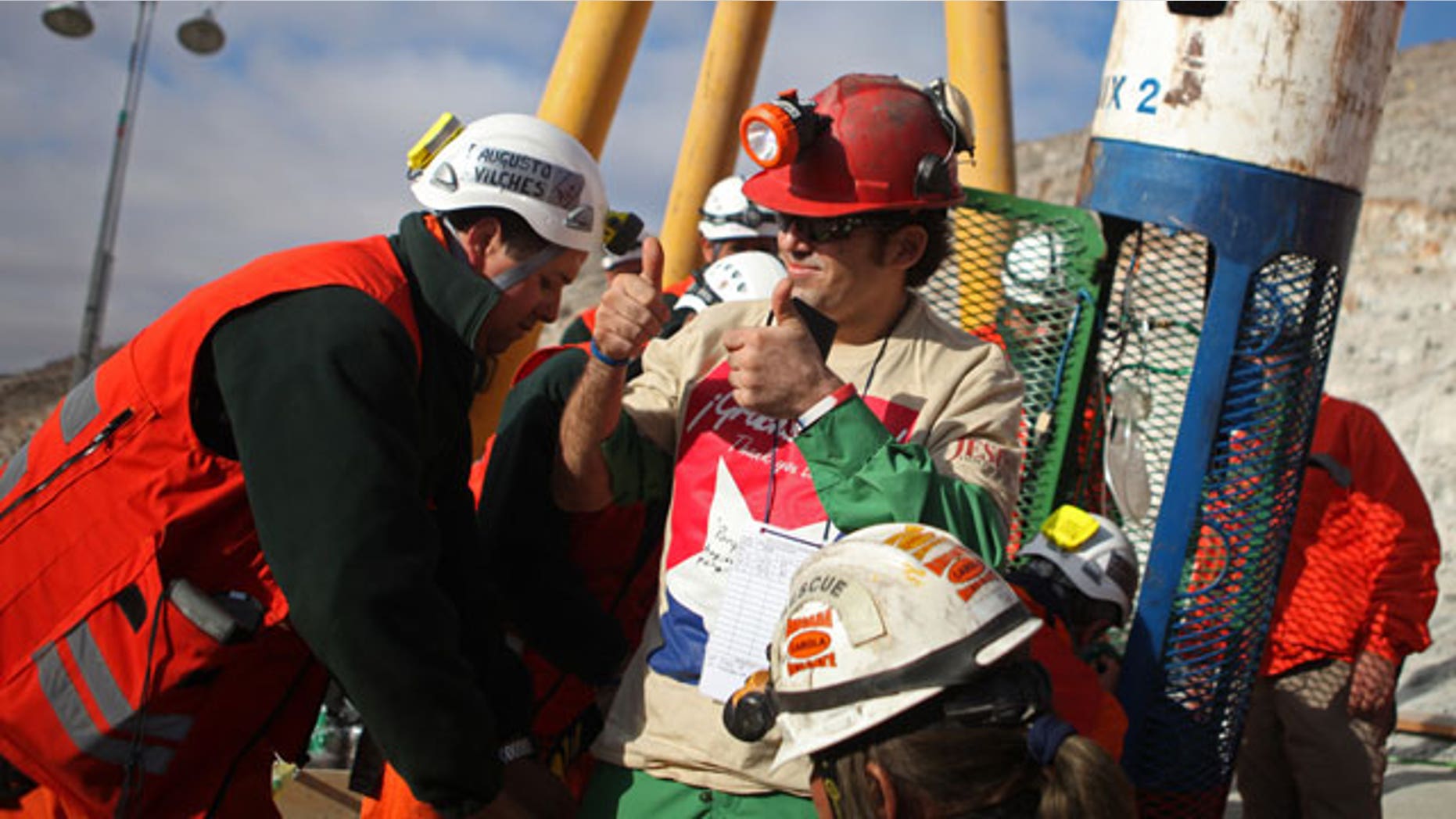 In this photo released by the Chilean government, miner Alex Vega gestures after being rescued from the collapsed San Jose gold and copper mine where he had been trapped with 32 other miners for over two months near Copiapo, Chile, Wednesday Oct. 13, 2010.