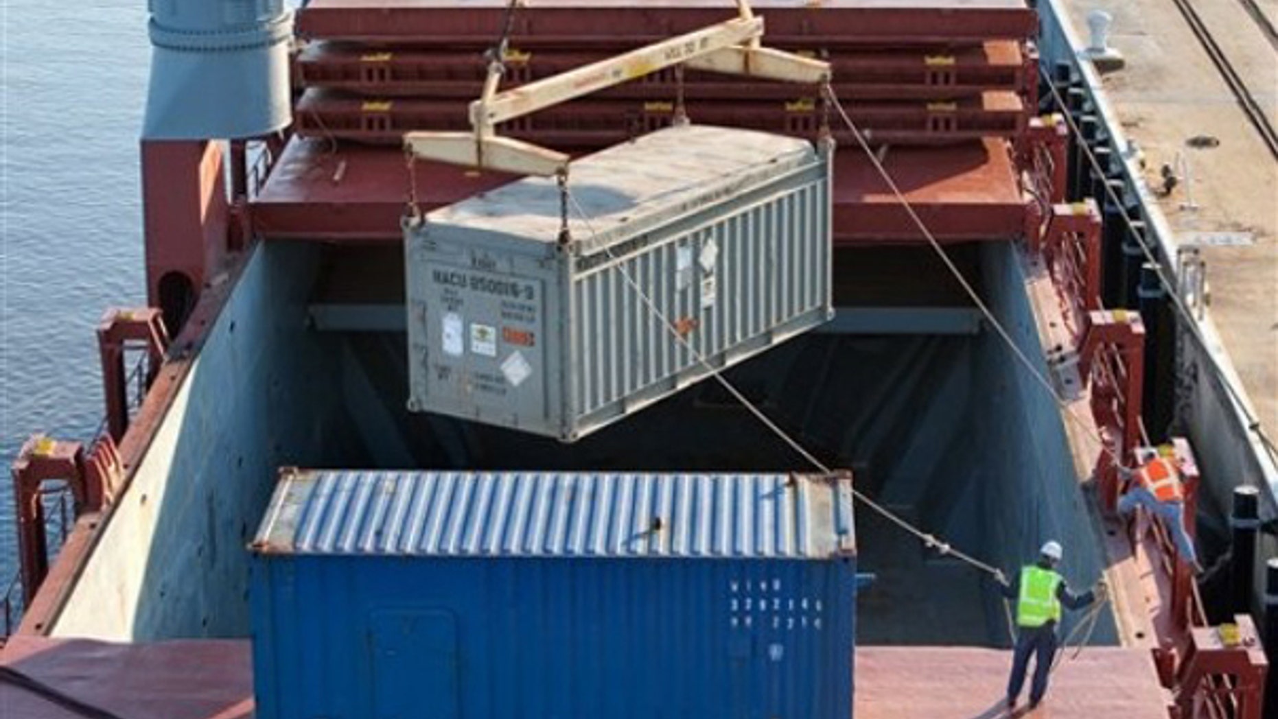 A massive crane lifts a container of highly enriched uranium from Chile bound for the Savannah River Site on a ship March 19. (AP Photo)