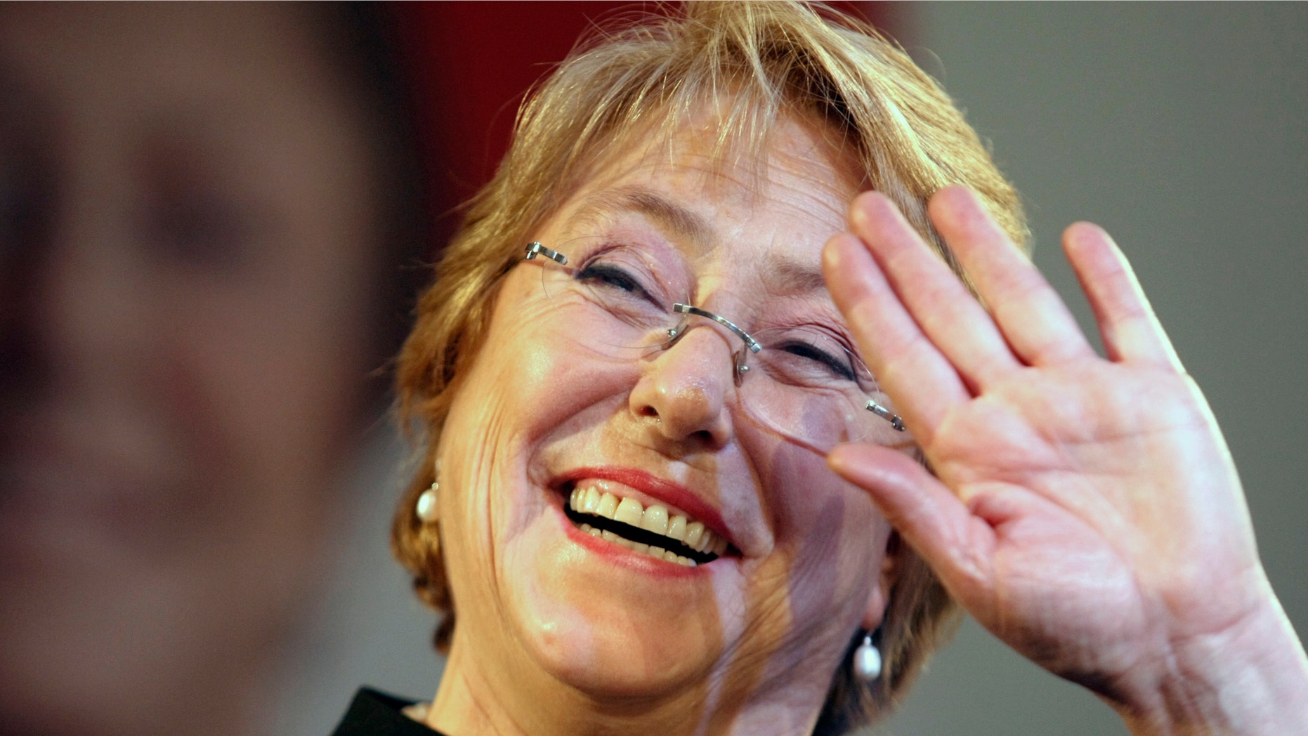 Former President Michelle Bachelet waves to supporters after winning presidential primaries in Santiago, Chile, Sunday June 30, 2013.