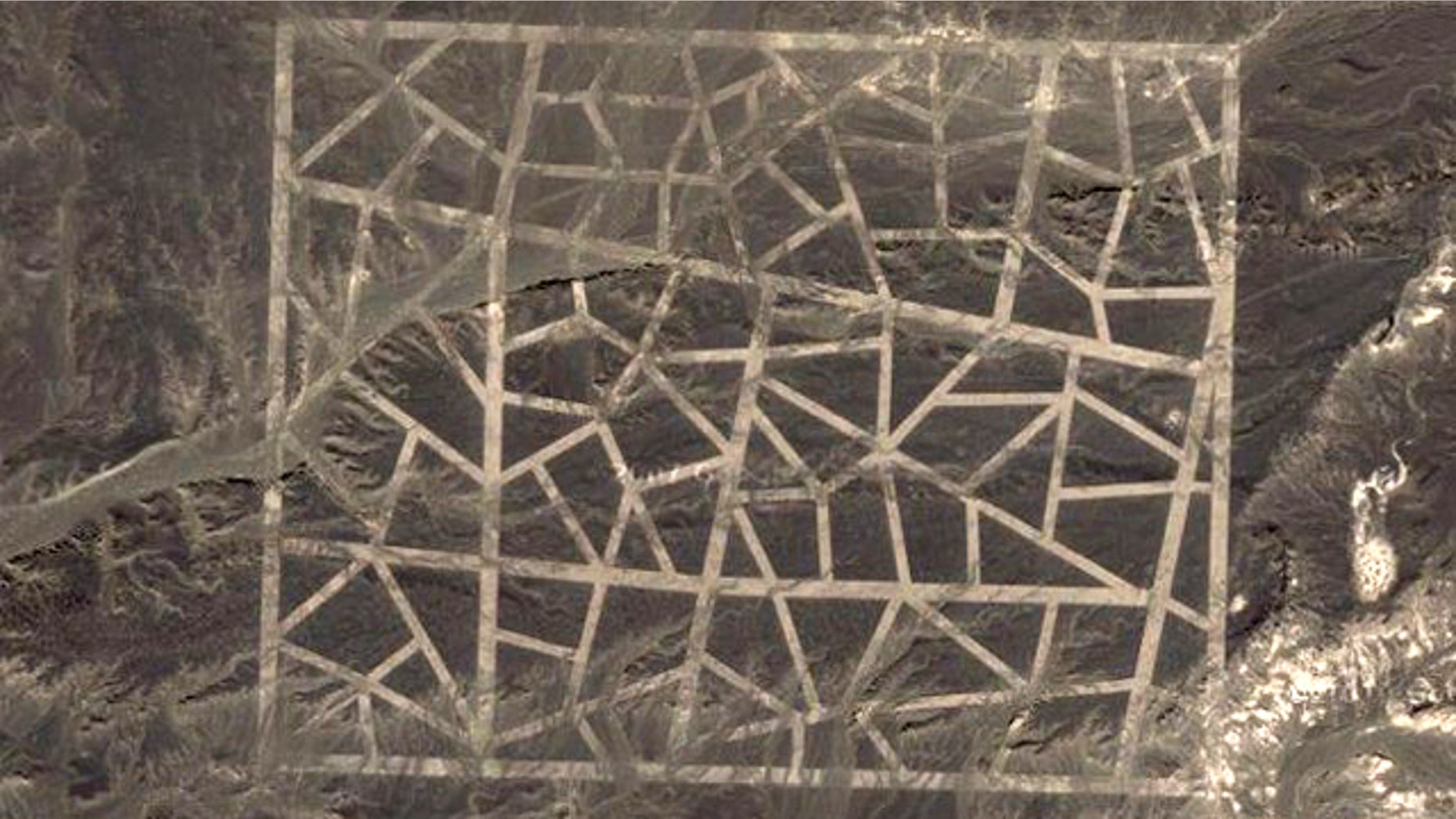 Conspiracy theorists are having a field day with new images from Google Earth showing strange patterns covering miles of Chinese desert.