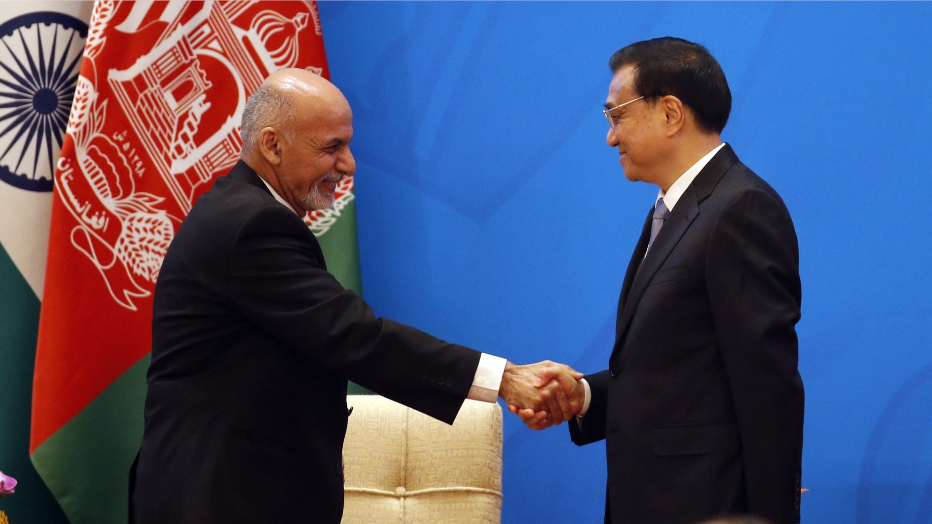 Chinese Premier Li Keqiang, right, shakes hands with Afghan President Ashraf Ghani Ahmadzai at opening ceremony of the 4th Ministerial Conference of Istanbul Process of Afghanistan.