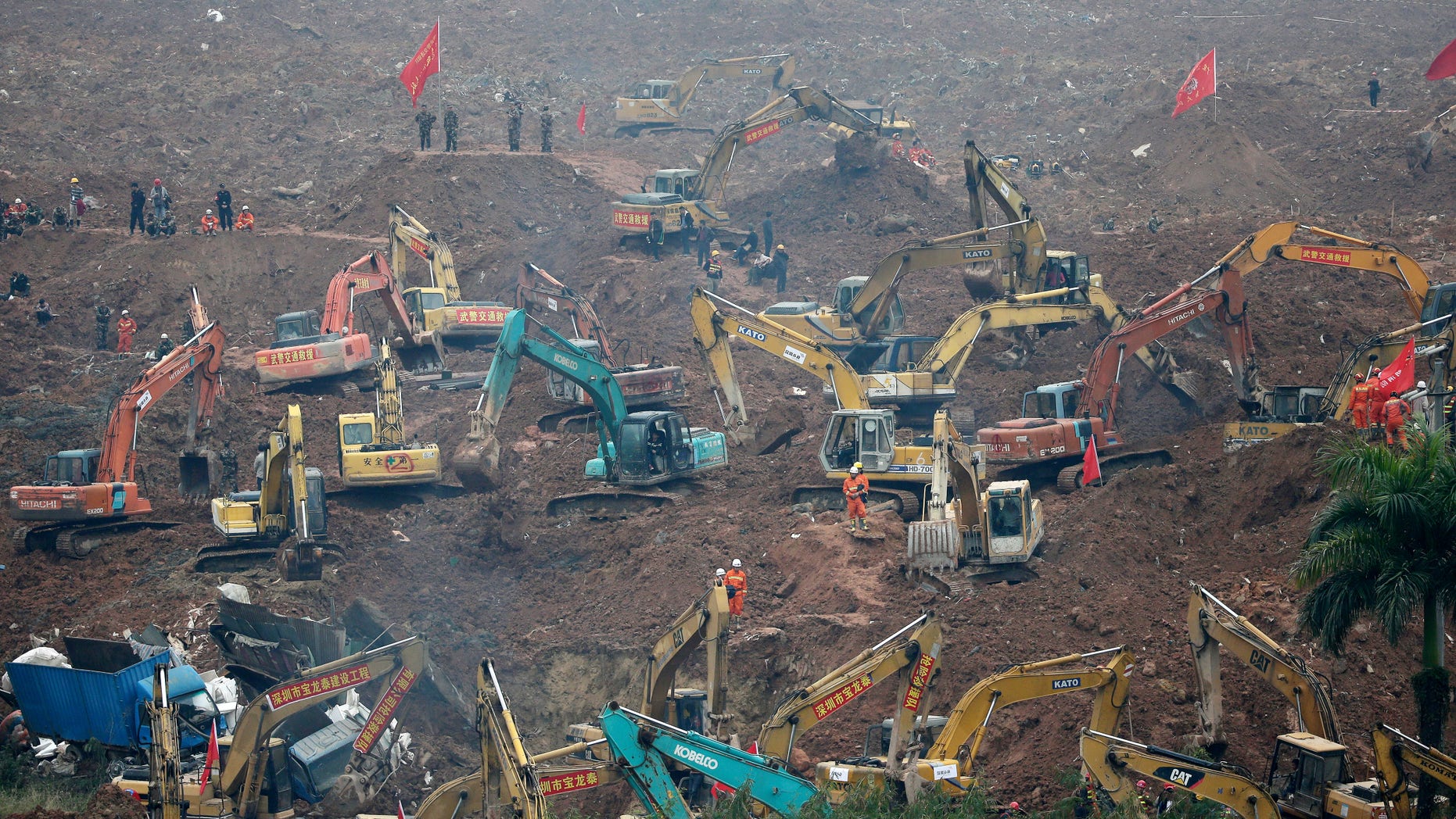 Dec. 21, 2015: Rescuers use machinery to search for potential survivors following a landslide in Shenzhen, in south China's Guangdong province. A mountain of excavated soil and construction waste buried dozens of buildings when it swept through an industrial park Sunday. (AP)