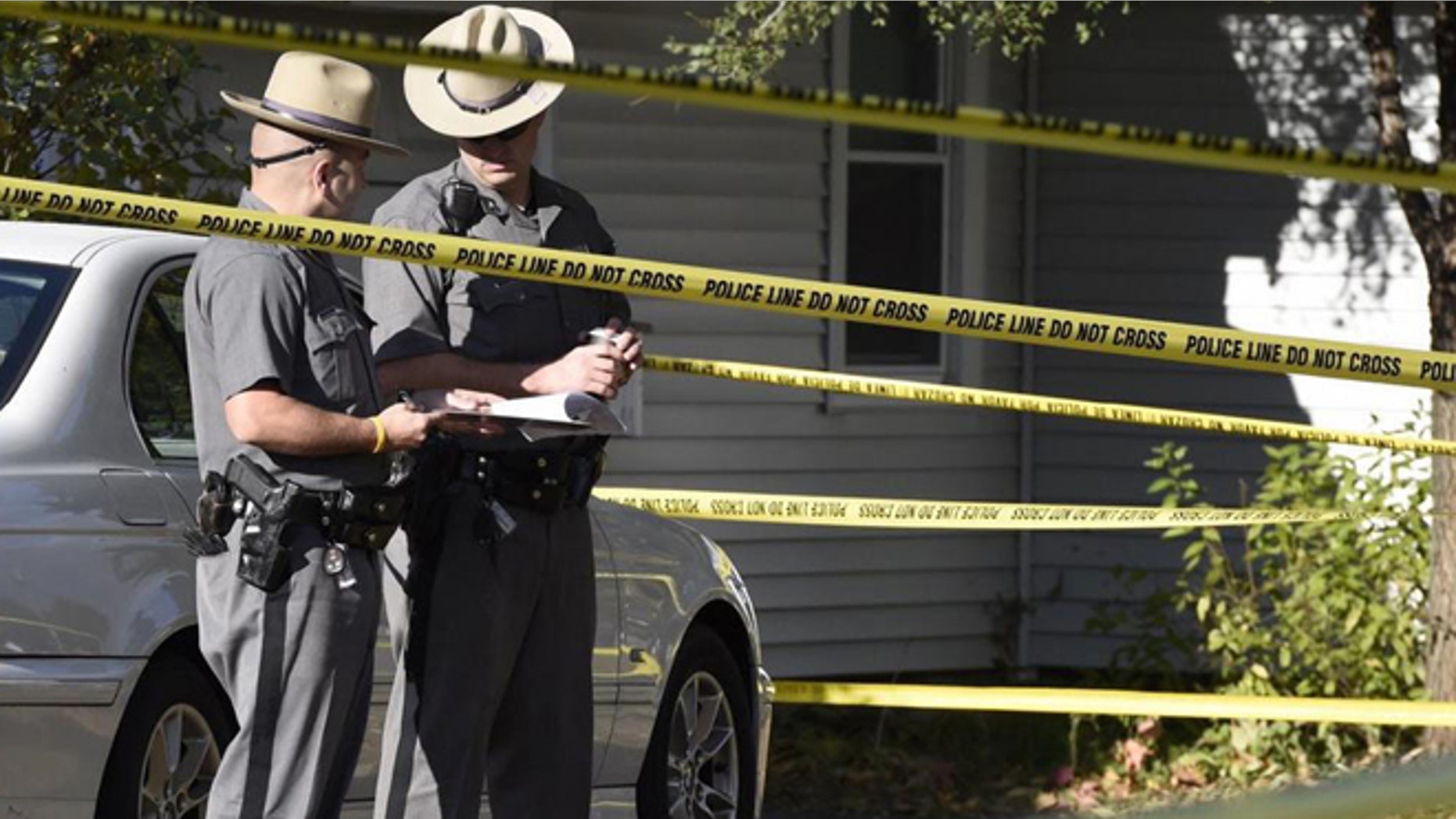 Oct. 10, 2014: Authorities work the scene of a quadruple homicide in Guilderland, N.Y., where Jin Chen, his wife and their two children were found fatally stabbed.