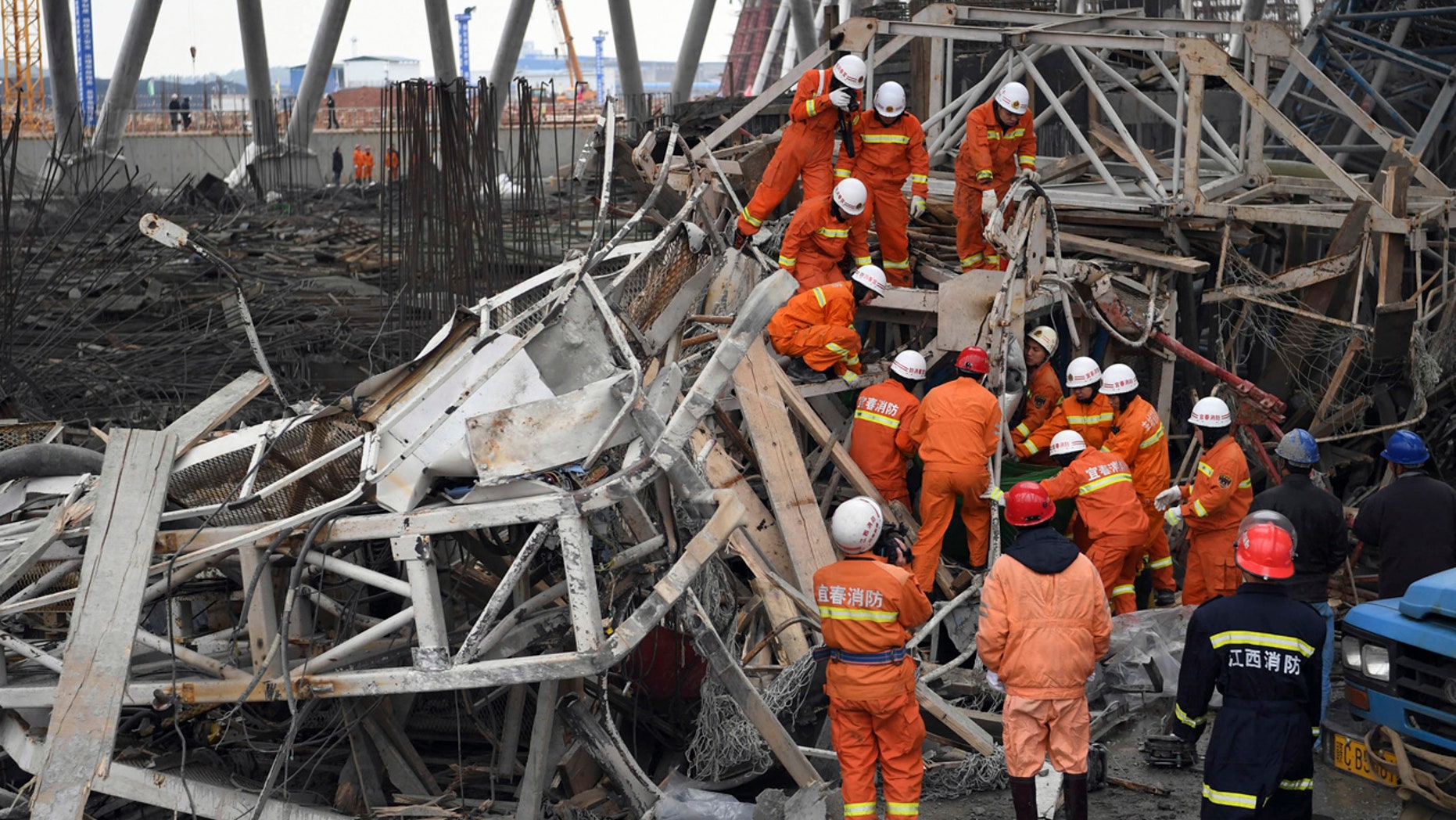In this photo released by Xinhua News Agency, rescue workers look for survivors after a work platform collapsed at the Fengcheng power plant in eastern China's Jiangxi Province, Nov. 24, 2016.