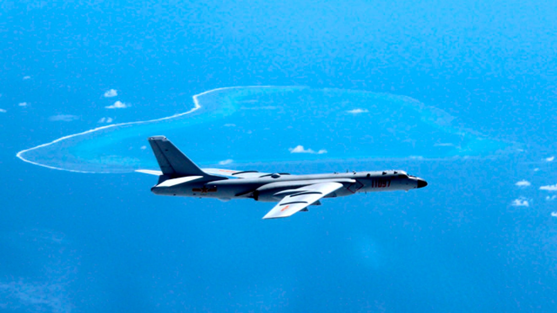 In this undated file photo released by Xinhua News Agency, a Chinese H-6K bomber patrols the islands and reefs in the South China Sea.