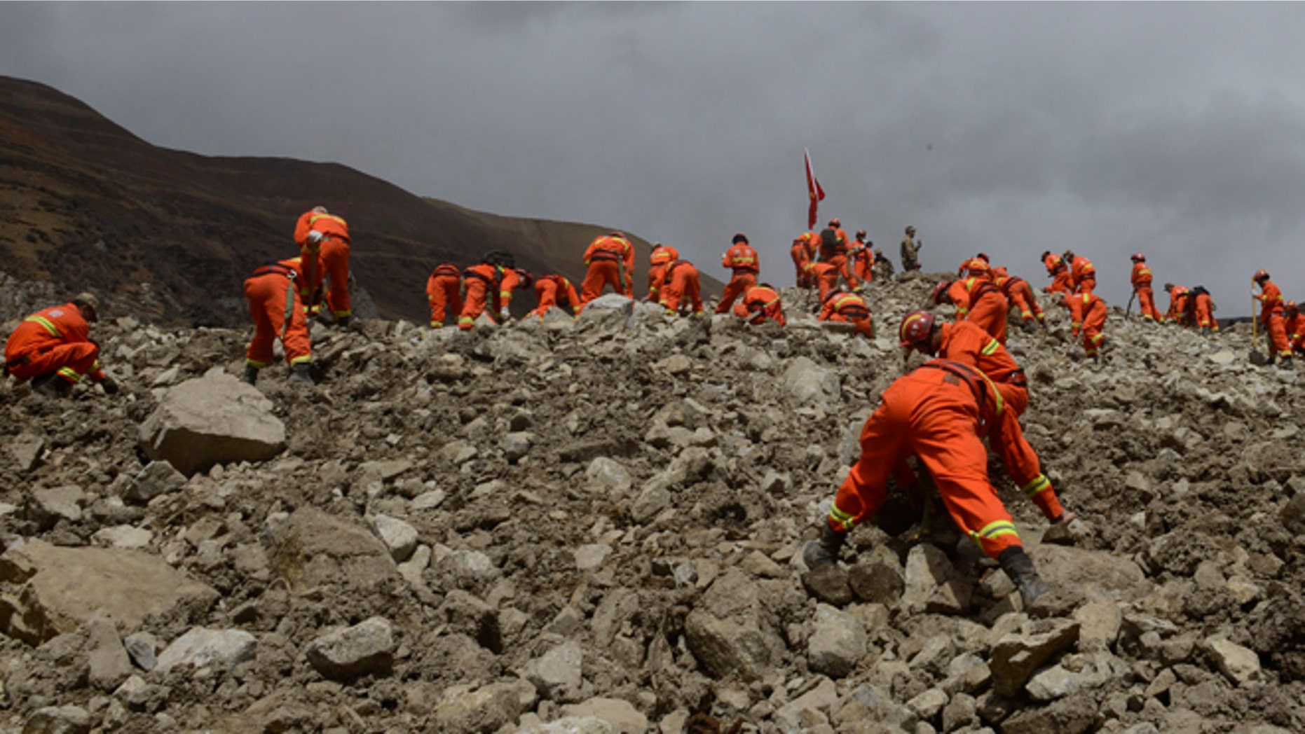 March 30, 2013: In this photo provided by China's Xinhua News Agency, rescue workers conduct search and rescue work at the site where a large-scale landslide hit a mining area in Maizhokunggar County of Lhasa, southwest China's Tibet Autonomous Region. Emergency crews in Tibet slogged through pileups of earth up to 100 feet deep Sunday after a massive mudslide at a gold mine buried 83 workers, and authorities said chances were slim for finding any survivors.