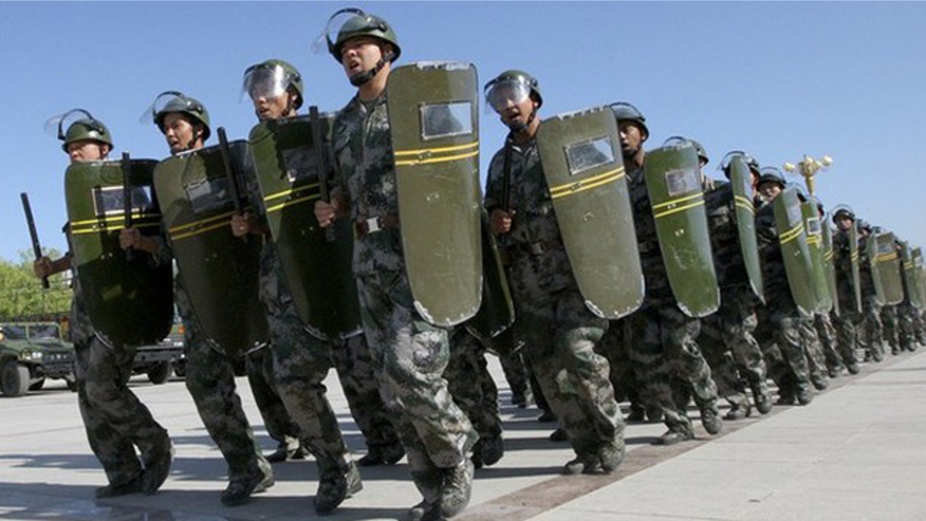 June 28, 2012: Members of the militia, a civilian reserve force under China's military, shout slogans as they march during an anti-terrorism exercise in Hami, in northwestern China.