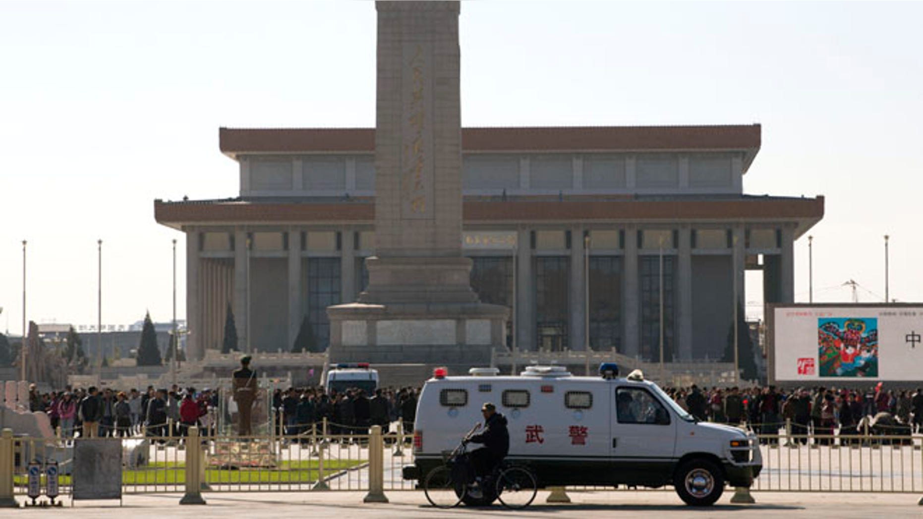 Oct. 29, 2013: An armored Chinese paramilitary vehicle is stationed near Tiananmen Square across the street from Tiananmen Gate, the site of an incident Monday where a car plowed through a crowd before it crashed and burned in Beijing, China.