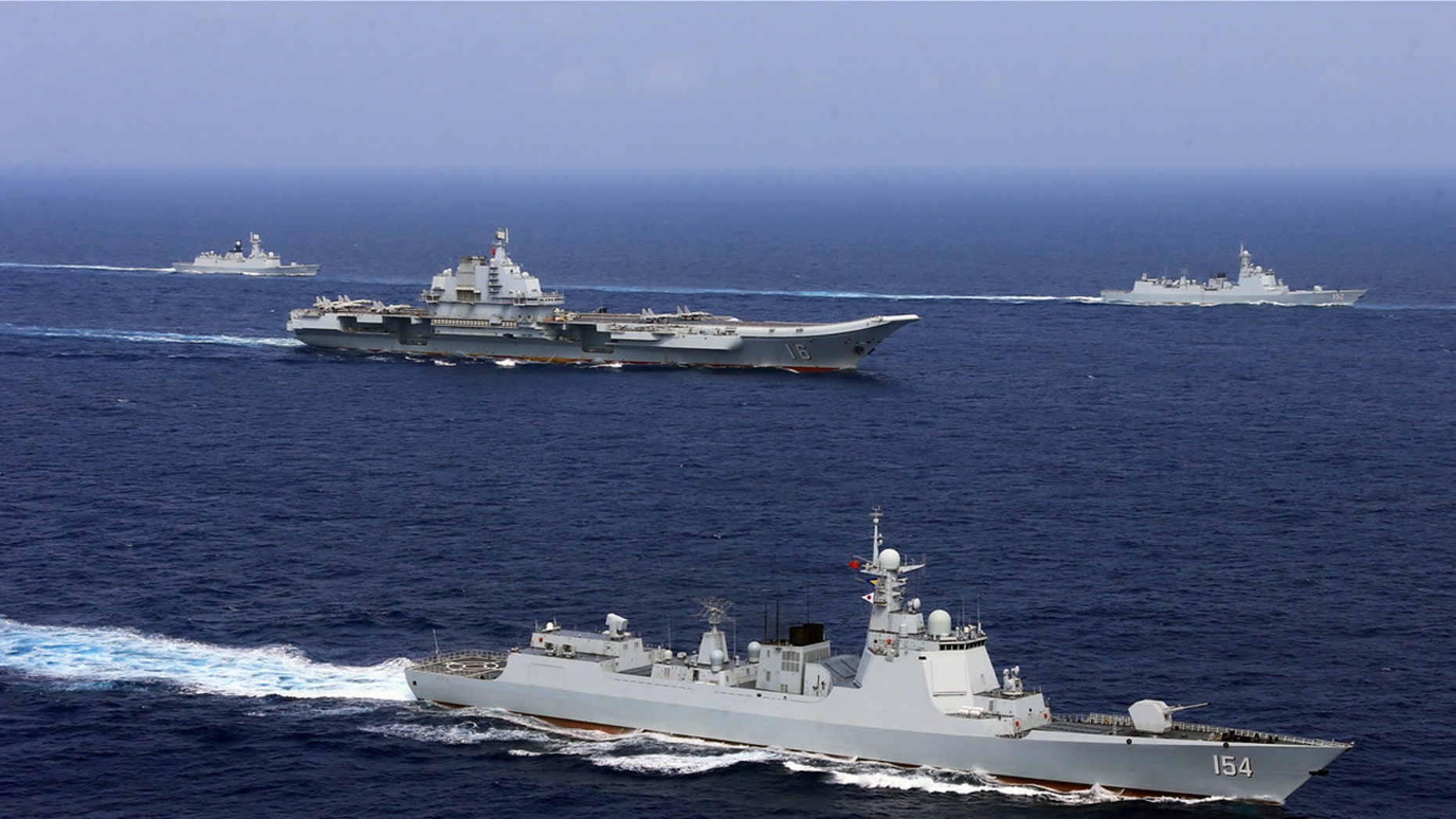 China's aircraft carrier Liaoning (C) takes part in a military drill of Chinese People's Liberation Army (PLA) Navy in the western Pacific Ocean, April 18, 2018.