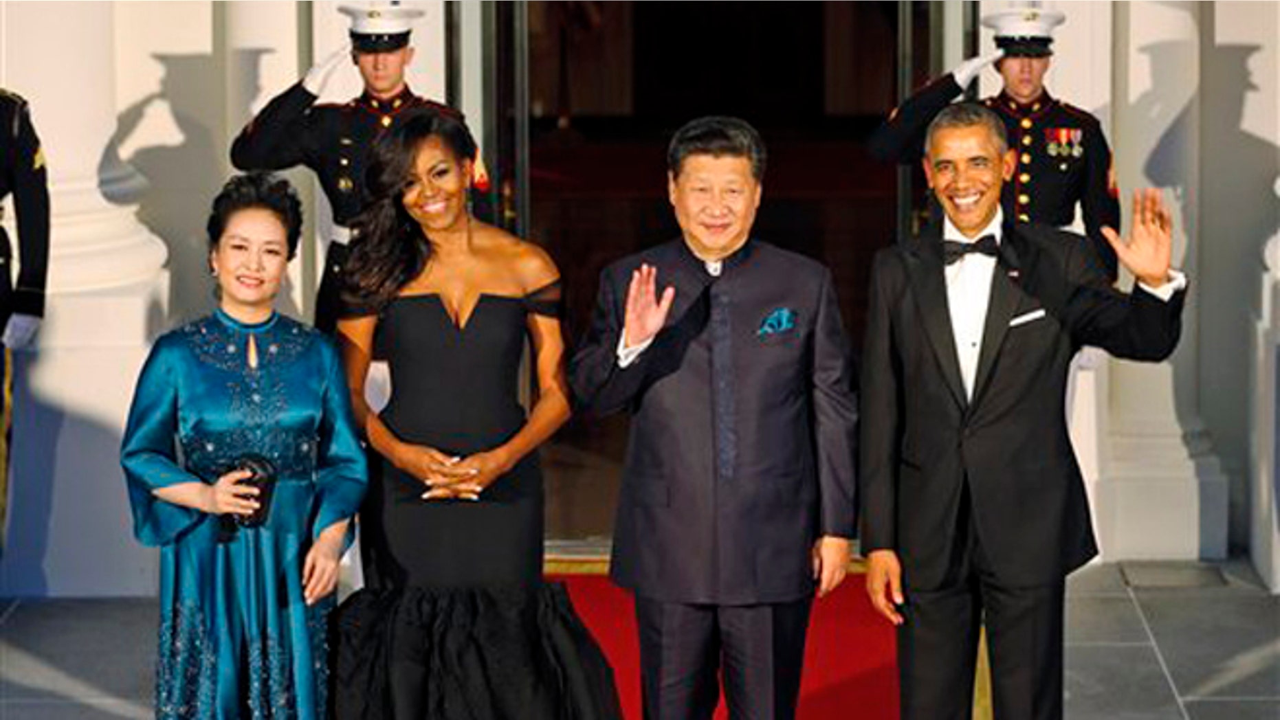 Sept. 25, 2015: President Barack Obama, right, and Chinese President Xi Jinping, second from right, wave along with, wives Peng Liyuan, left, and first lady Michelle Obama as they arrive for a state dinner at the White House in Washington.
