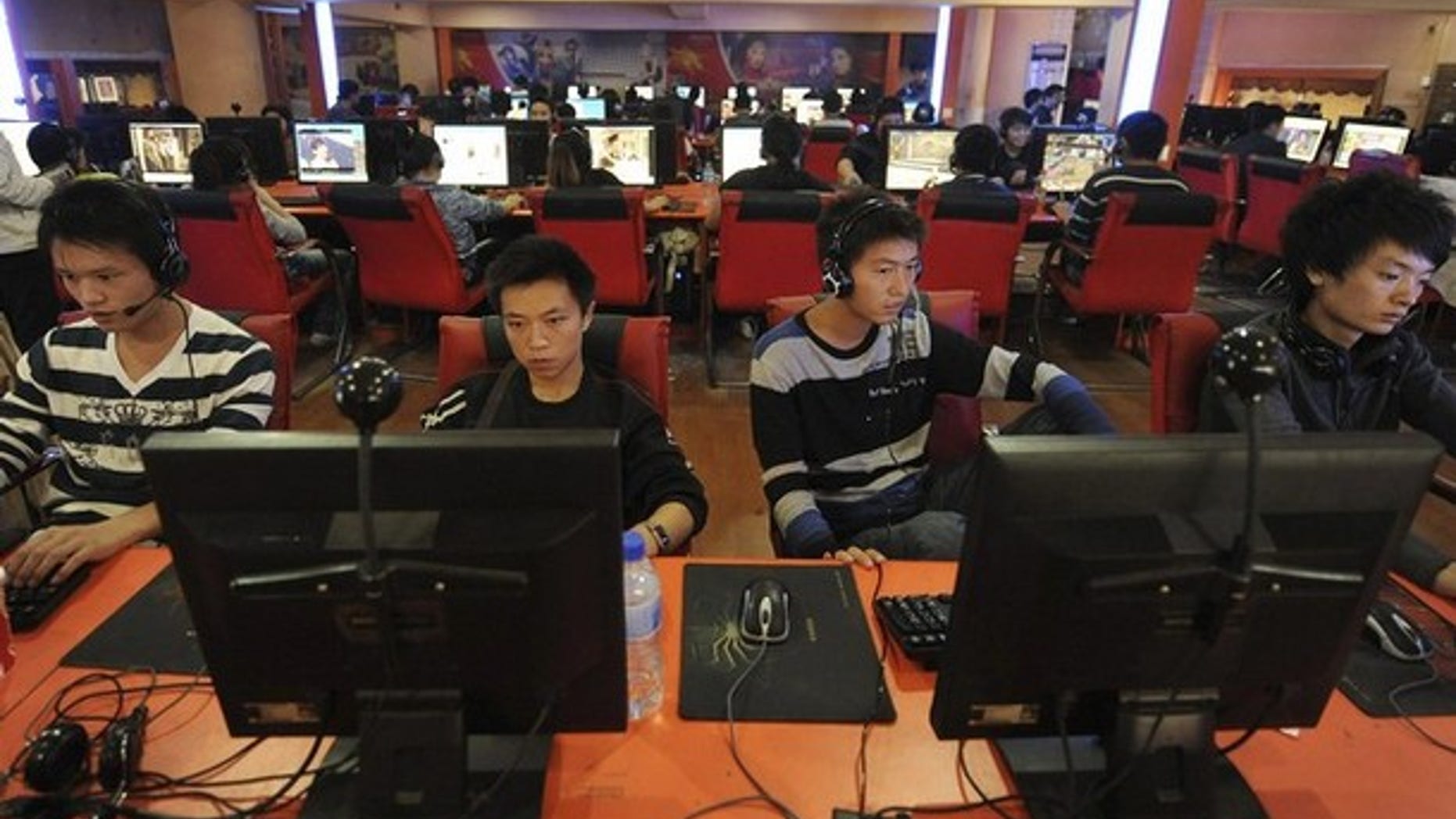 People use computers at an Internet cafe in Hefei, Anhui province, China.