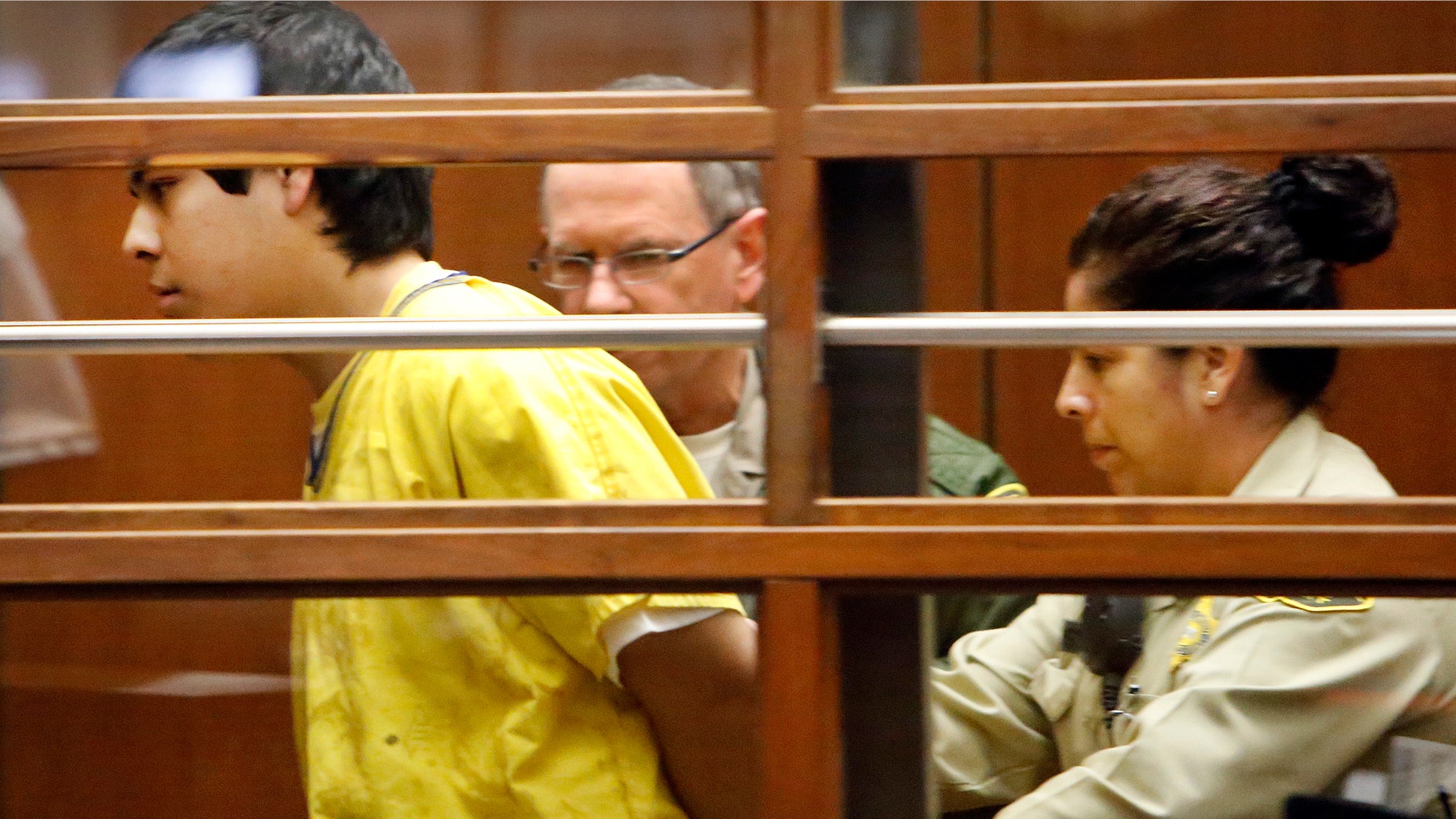 Jan. 12, 2015: Andrew Garcia, left, is led out of the courtroom by Sheriff's bailiffs after an outburst during an appearance in Los Angeles Superior Court Monday.