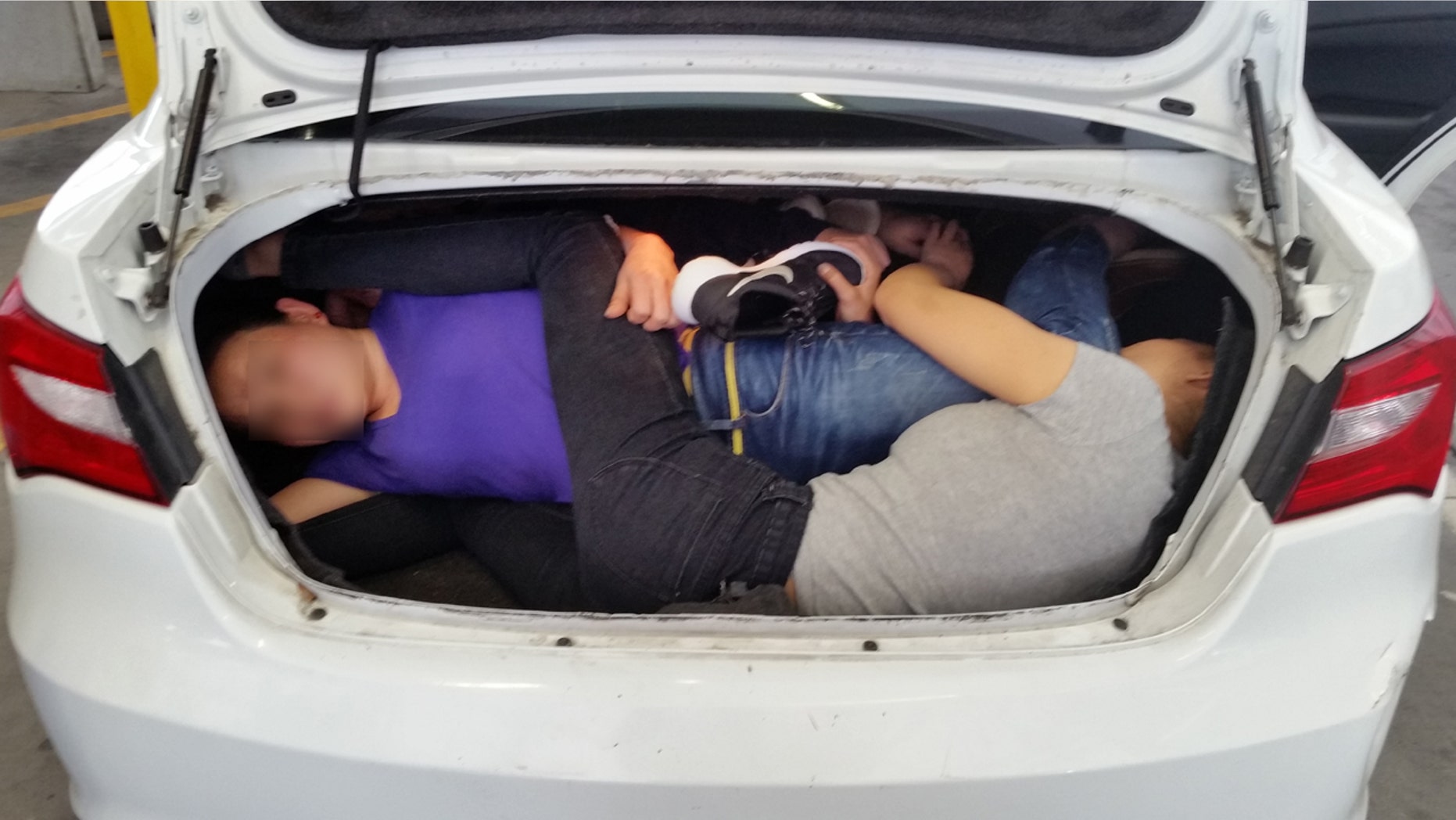 US customs officers discovered four Chinese citizens crammed into the trunk of a car at the US/Mexico border.
