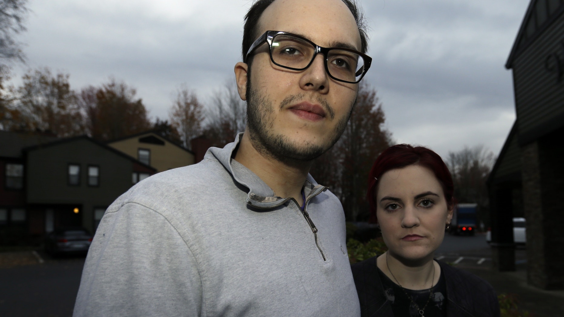 Chris Collins, left, poses for a photo with his wife, Kellie, outside their Lake Oswego, Ore., home Wednesday, Nov. 4, 2015. (AP Photo/Don Ryan)