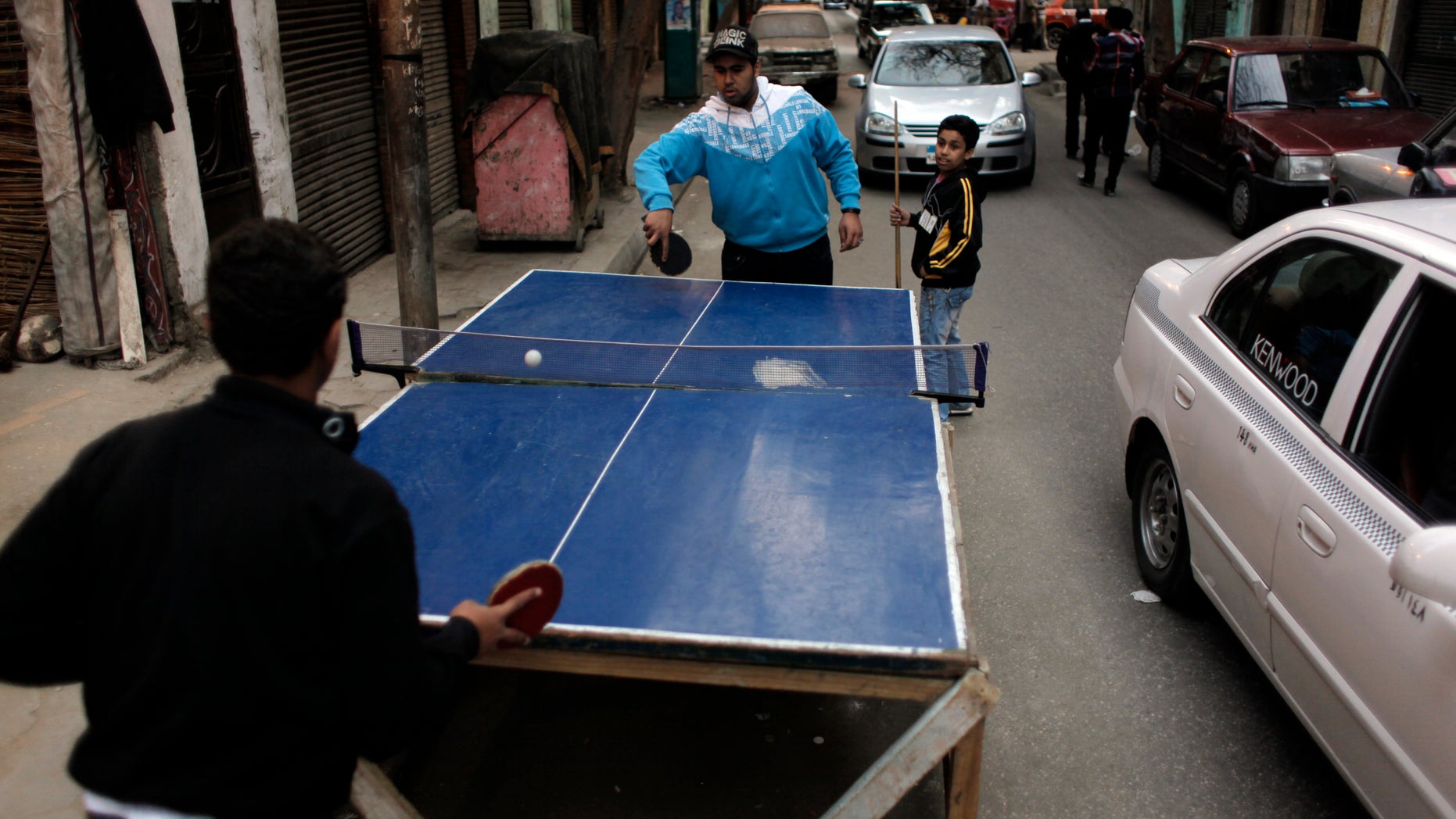 March 25: Two Egyptian youths play table tennis while they occupy part of a street in Cairo, Egypt.