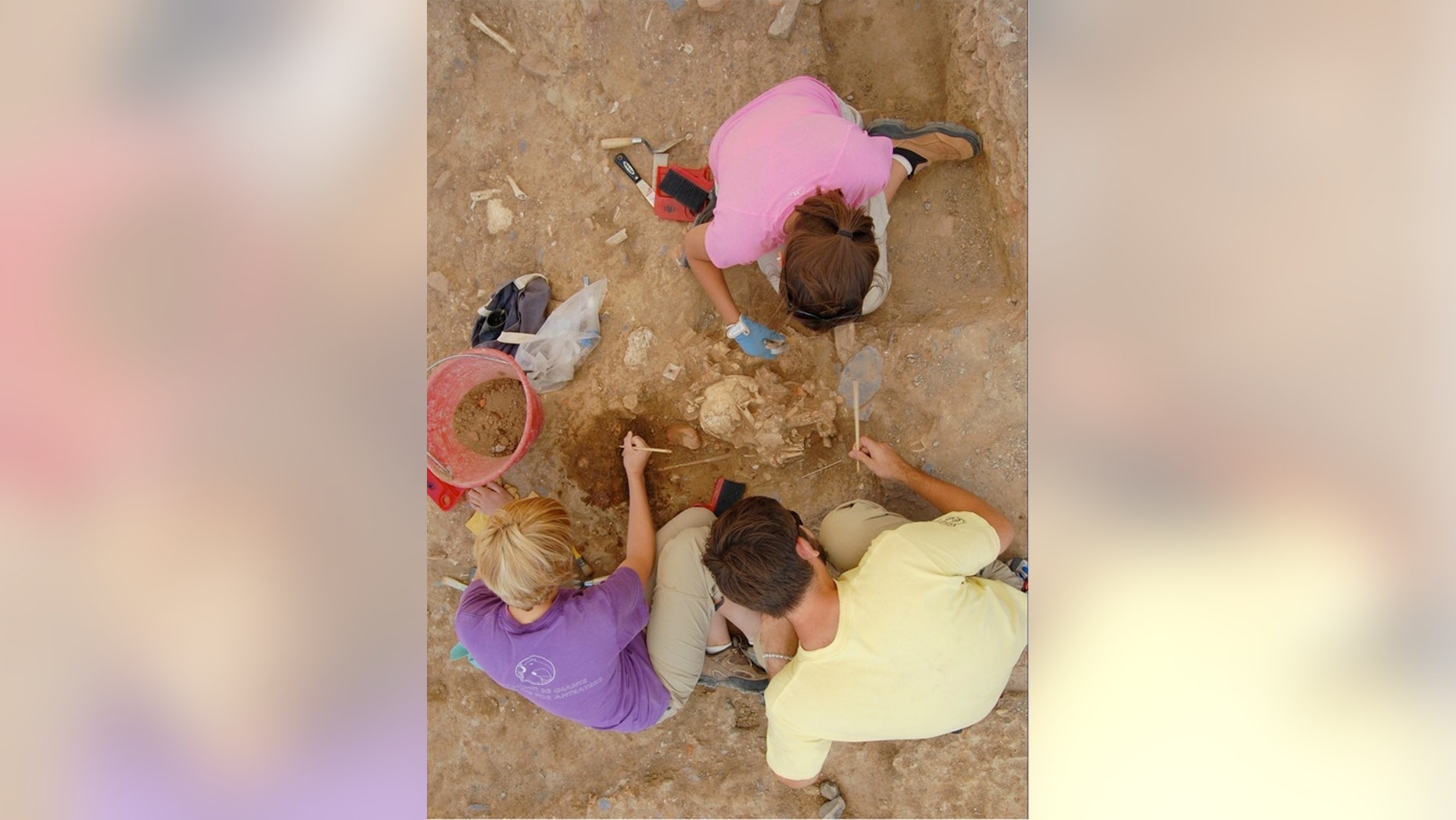 Students excavate bones at the Badia Pozzeveri cemetery in Tuscany, Italy.