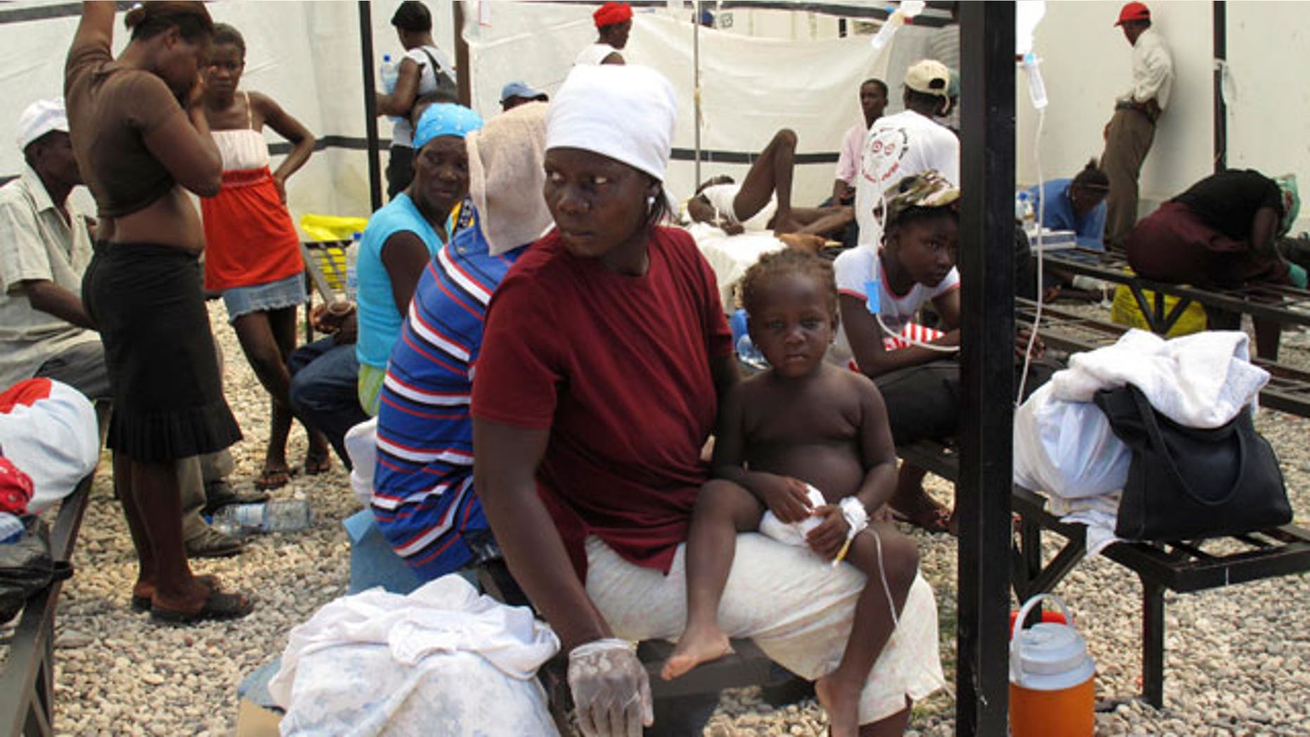 Haitians suffering from cholera wait for medical treatment with their relatives at a local hospital in the town of Saint Marc October 22, 2010. Quake-hit Haiti and its aid partners fought on Friday to stem a cholera epidemic that has killed over 150 people and sickened hundreds, with experts saying more cases could be expected before it was contained.