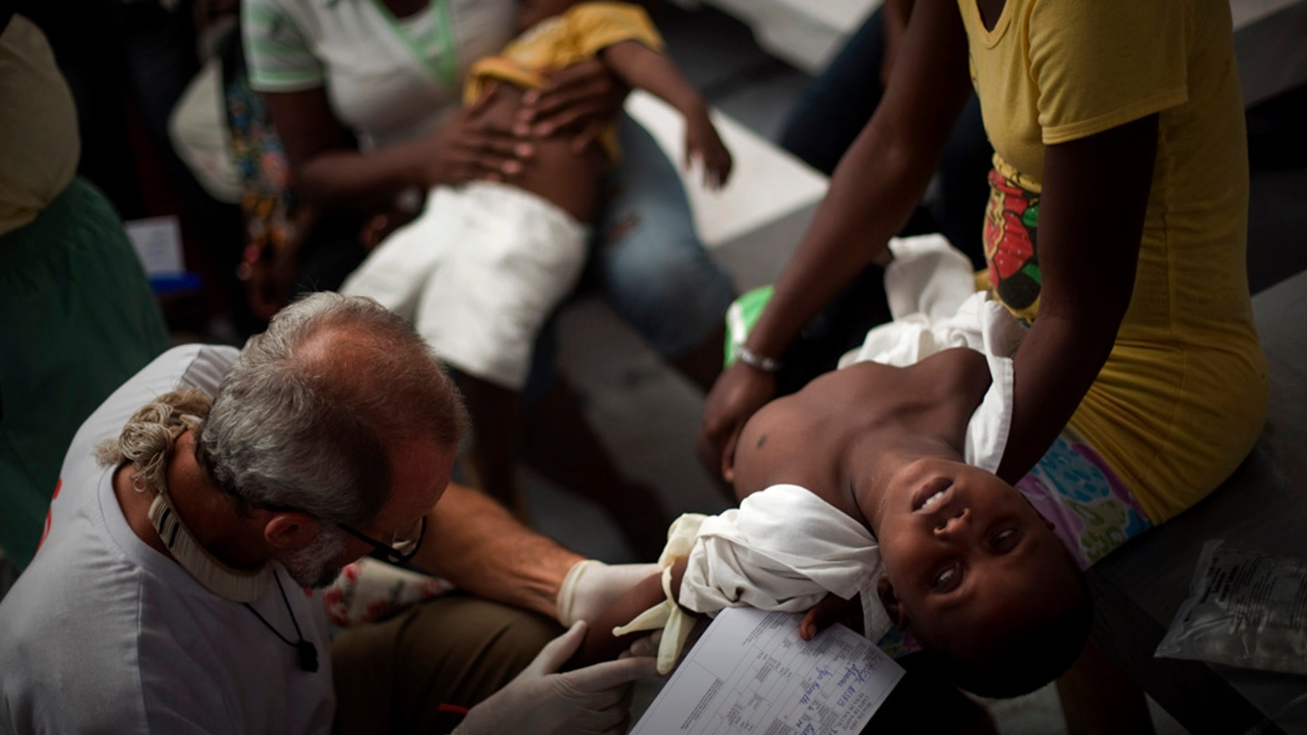 A child suffering cholera symptoms is checked by a doctor at the Doctors Without Borders temporary hospital in Port-au-Prince, Haiti, Tuesday Nov. 16, 2010. Thousands of people have been hospitalized for cholera across Haiti with symptoms including serious diarrhea, vomiting and fever and hundreds have died. (AP Photo/Emilio Morenatti)