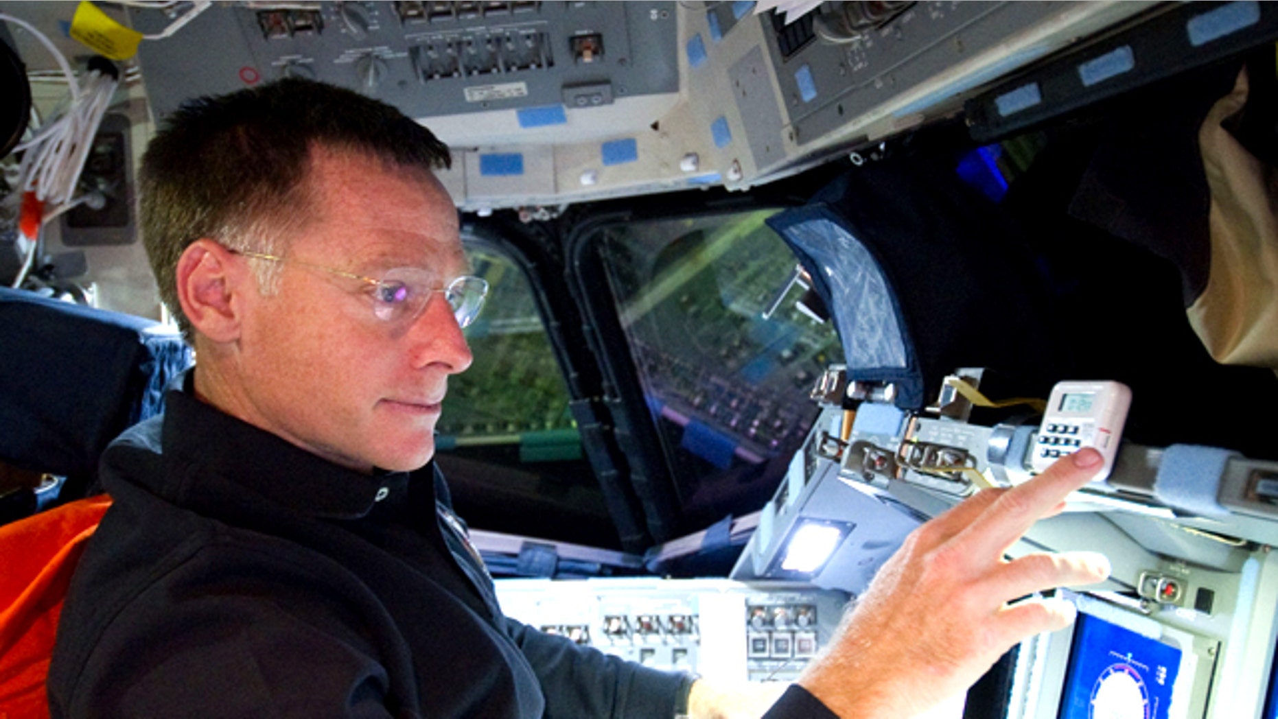 Astronaut Chris Ferguson, STS-135 commander, is pictured at the commander's station on the forward flight deck of the space shuttle Atlantis during the STS-135 mission's third day in space.