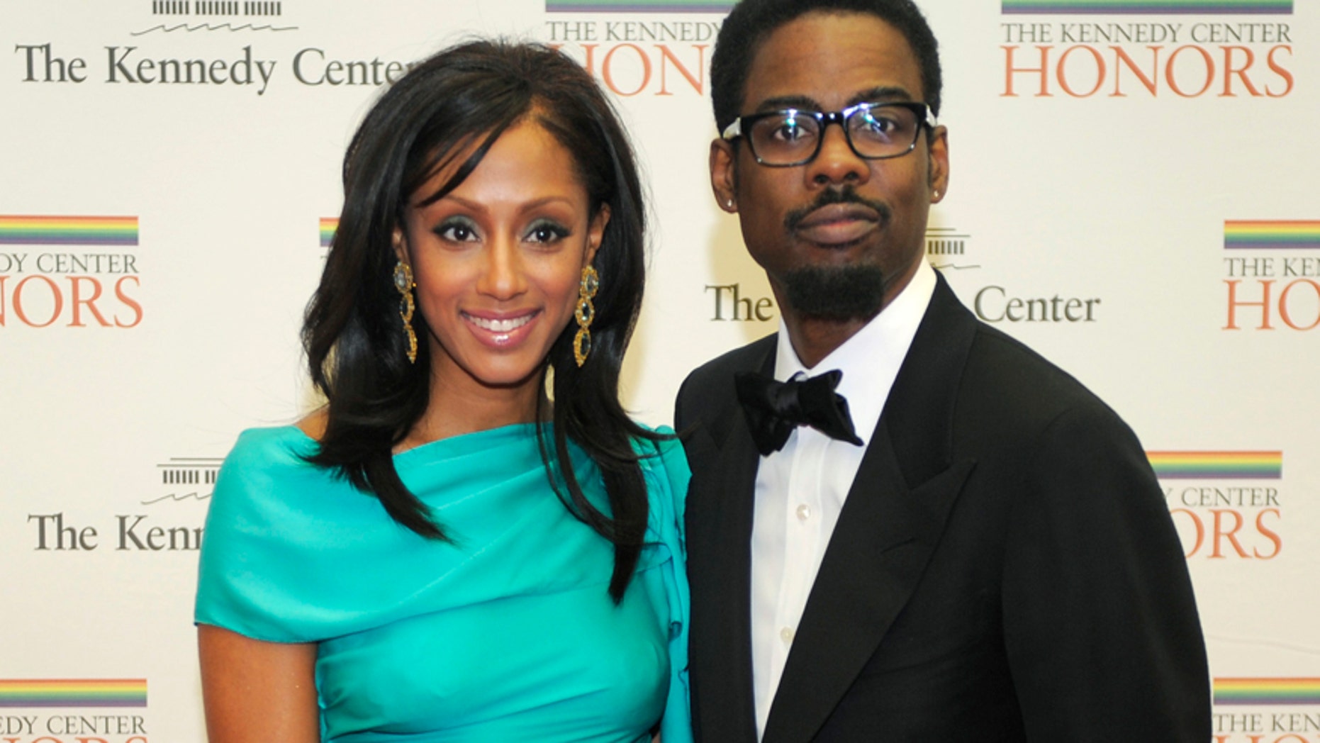 Comedian Chris Rock and his wife Malaak pose for photographers on the red carpet as they arrive at the State Department for a gala dinner for the 2010 Kennedy Center Honorees in Washington December 4, 2010.