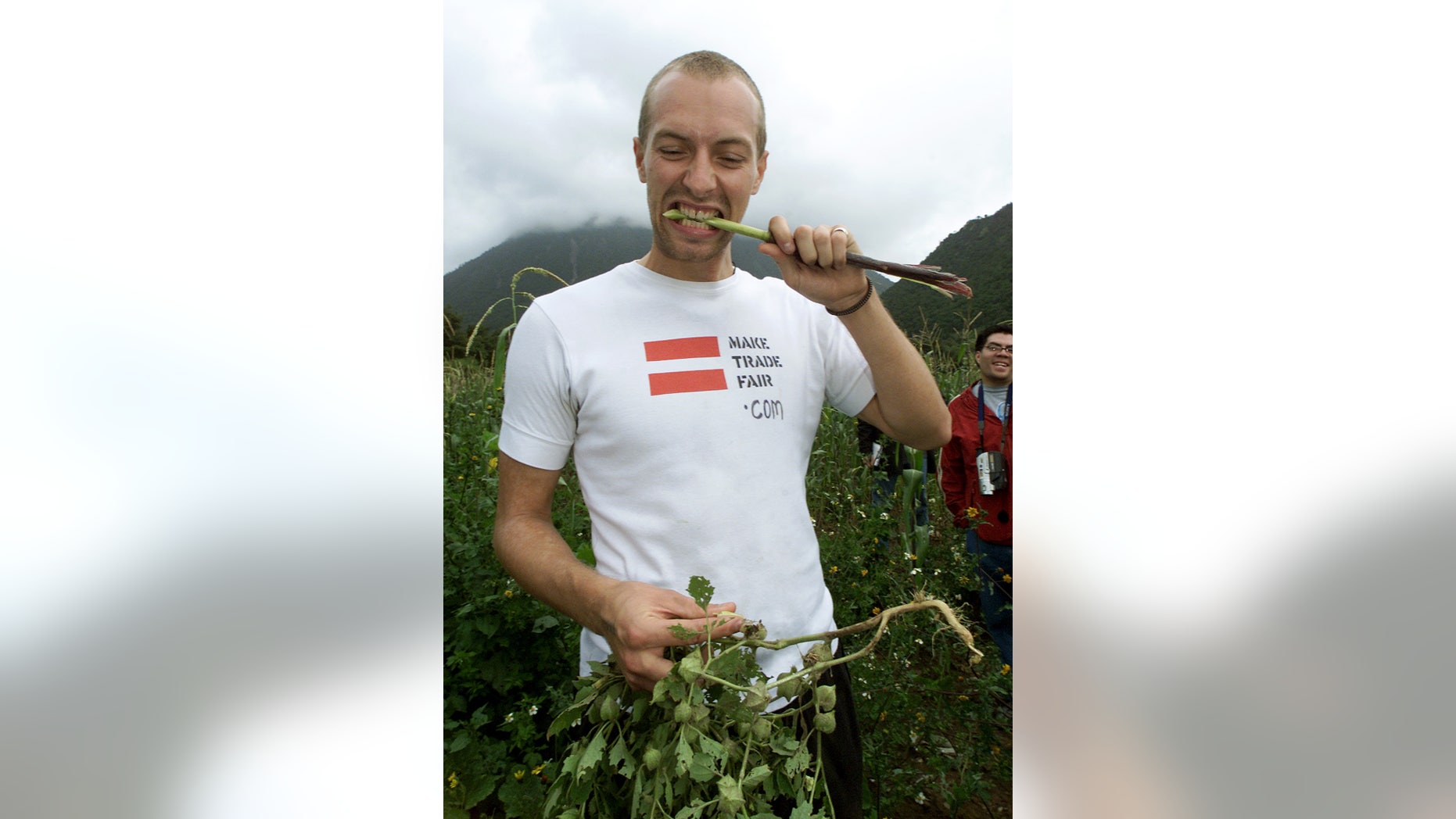September 6, 2003. Coldplay band vocalist Chris Martin tastes a stalk of sweet corn canein a corn field owned by a cooperative in Puebla state, outside of Mexico City.