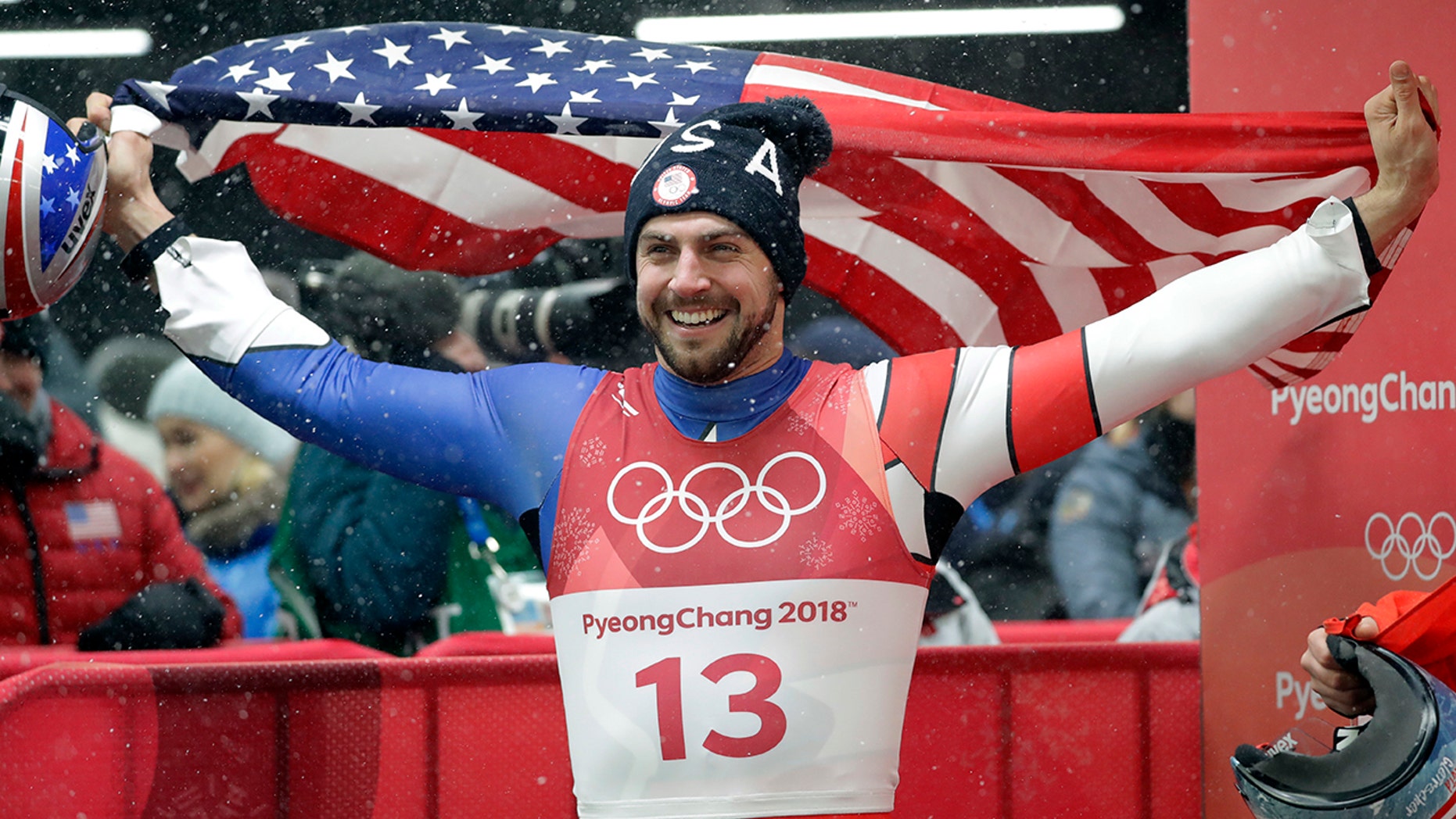 American Chris Mazdzer celebrates his historic silver medal win by eating a slice of pizza in one bite.