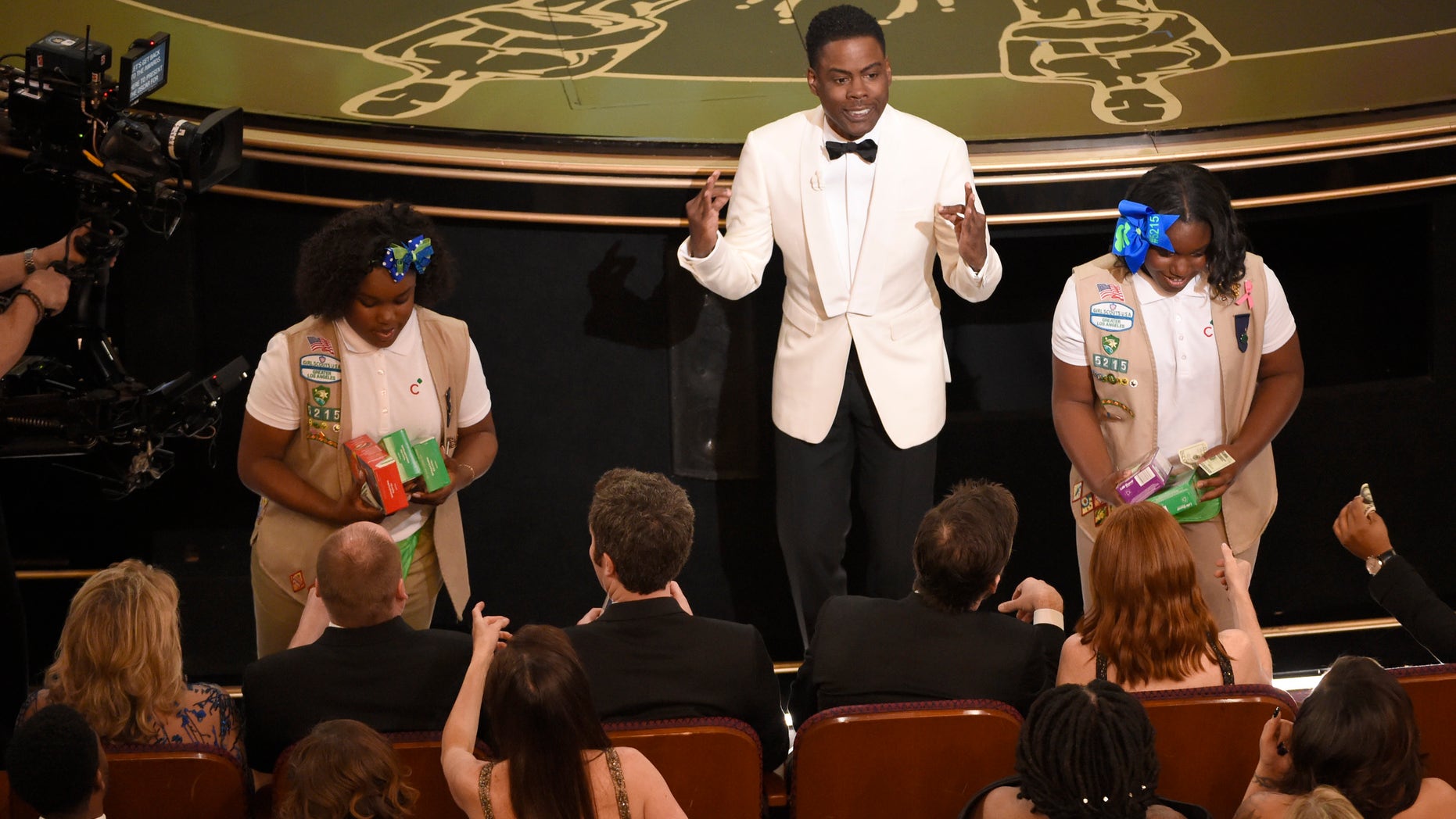 Host Chris Rock sells Girl Scout cookies in the audience at the Oscars on Sunday, Feb. 28, 2016, at the Dolby Theatre in Los Angeles. (Photo by Chris Pizzello/Invision/AP)
