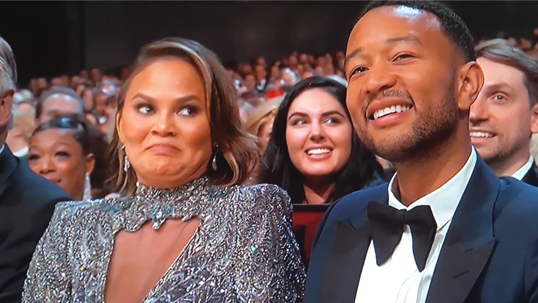 Chrissy Teigan addresses her Emmy Awards facial expression after awkward Colin Jost and Michael opening monologue joke.