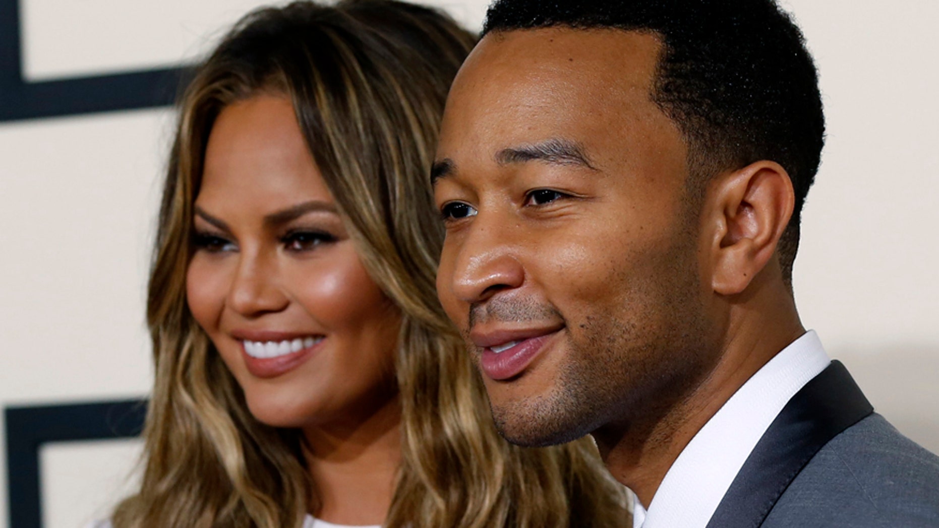 Singer John Legend arrives with wife Chrissy Teigen at the 57th annual Grammy Awards in Los Angeles, California February 8, 2015.