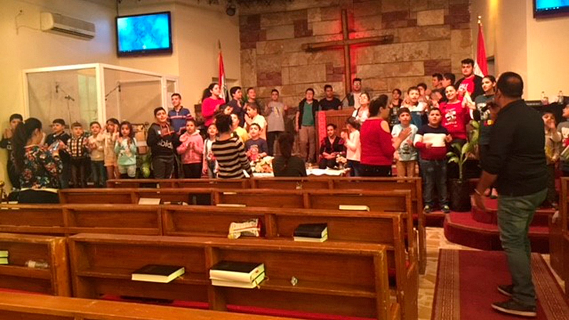 Children sing "Jingle Bells" and rehearse a Nativity play at the Alliance Evangelical Church in Baghdad.