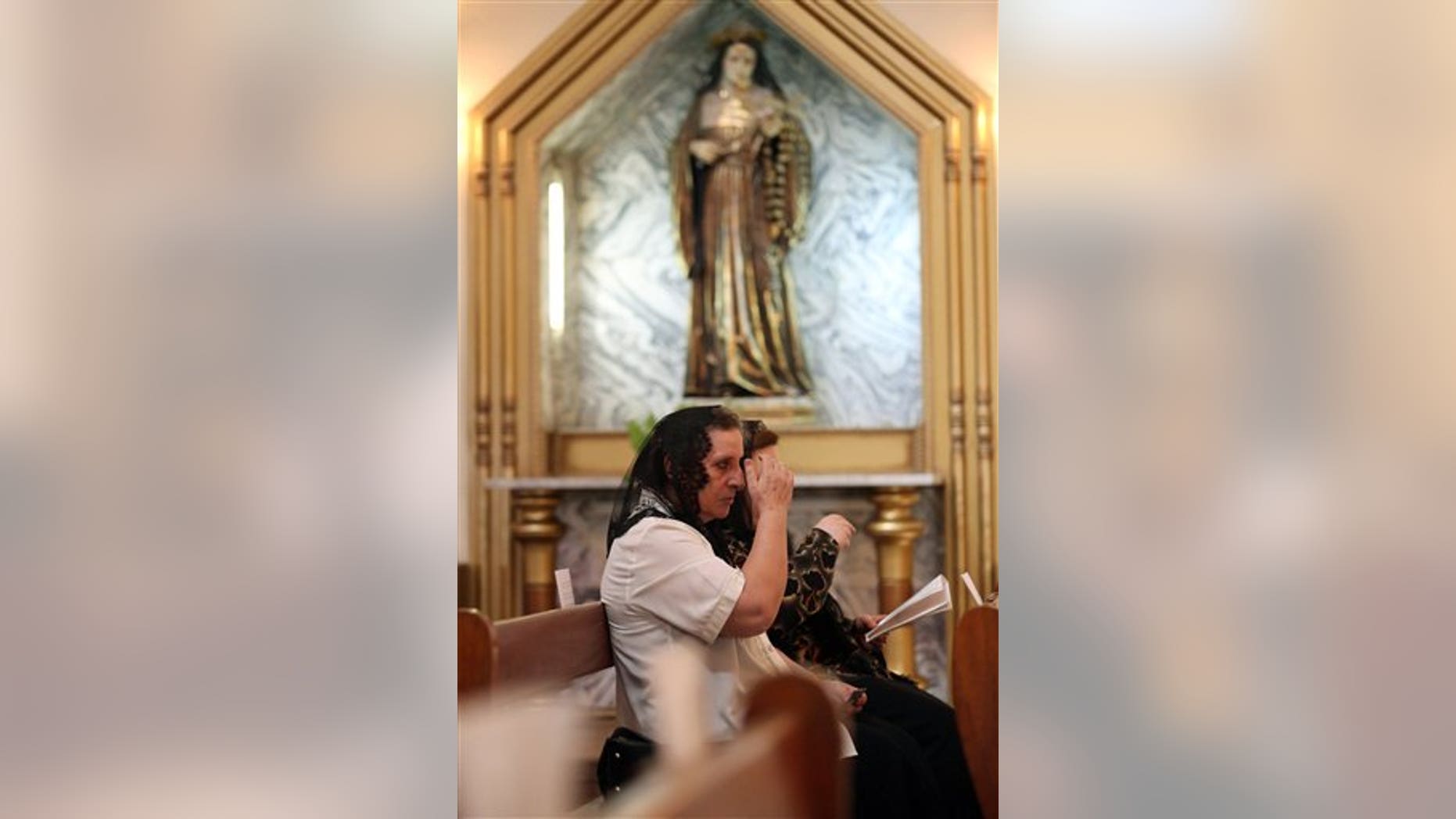Iraqi Christians pray during Sunday Mass at the Church of Virgin Mary in Baghdad, Sunday, July 27, 2014. (AP Photo/Hadi Mizban)