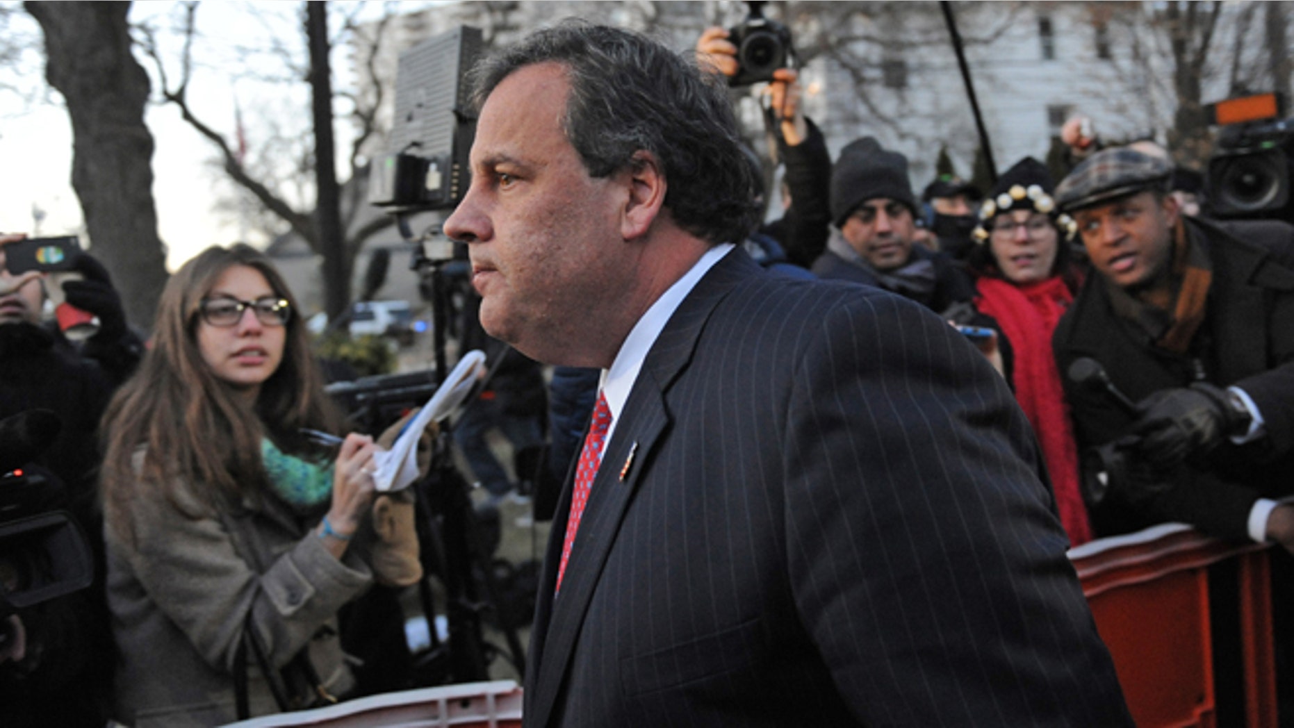 Jan 9, 2014: New Jersey Gov. Chris Christie walks past reporters as he leaves City Hall in Fort Lee, N.J.