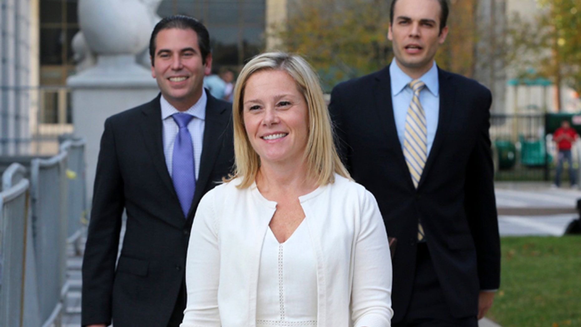 FILE - In this Wednesday, Oct. 19, 2016 file photo, Gov. Chris Christie's former Deputy Chief of Staff Bridget Anne Kelly, center, leaves Martin Luther King Jr. Courthouse after a hearing, in Newark, N.J. Kelly, who prosecutors say sent the "time for some traffic problems" email that started the George Washington Bridge lane-closing scandal is set to testify in her own defense. Kelly is expected to take the stand later Friday, Oct. 21, 2016, in federal court in Newark. (AP Photo/Mel Evans, File)