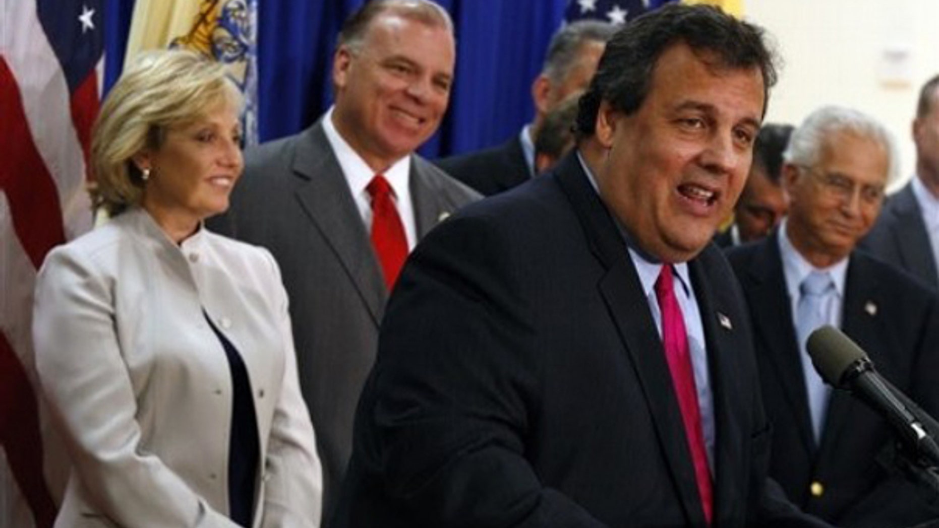 FILE: New Jersey Gov. Chris Christie, backed by Lt. Gov. Kim Guadagno and New Jersey Senate President Stephen Sweeney, speaks after signing the Property Tax Cap bill into law on July 13, 2010.