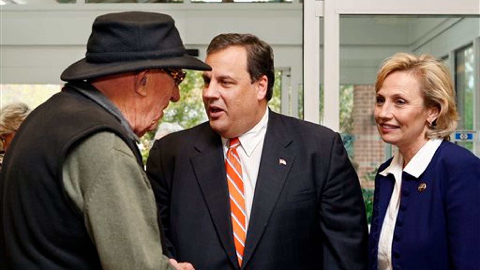 Monday: Republican gubernatorial candidate Chris Christie greets supporter Ben Ross, left, as lieutenant governor candidate Kim Guadagno, looks on in Tinton Falls, N.J. (AP Photo)