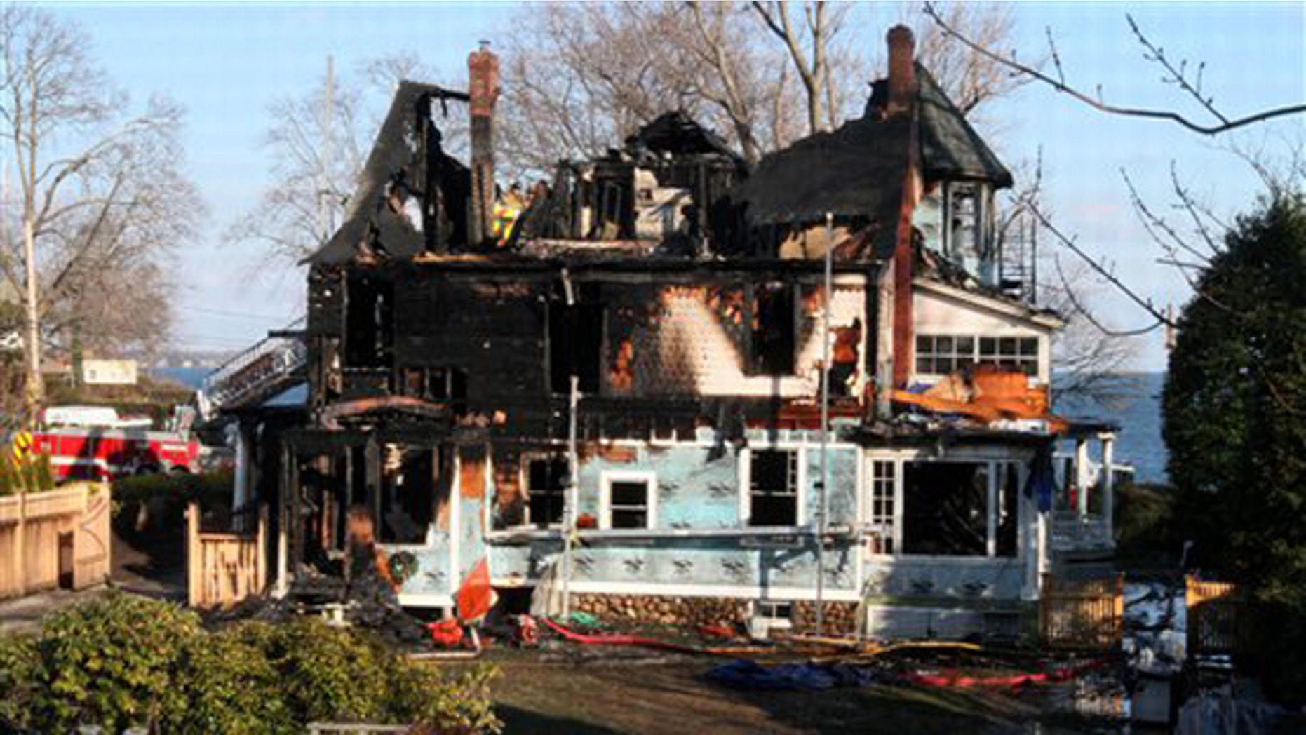 Dec. 25, 2011: In this file photo, firefighters investigate a house where an early morning fire left five people dead, in Stamford, Conn.