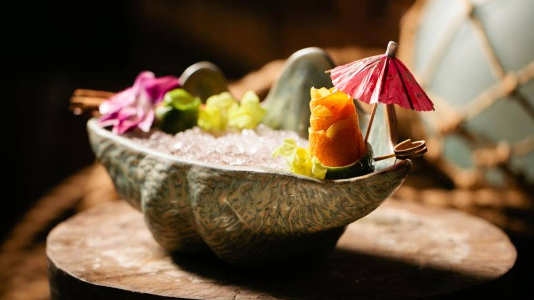 Ingredients
½ oz. Lemon Hart 151 Rum
½ Cockspur 5 Year Rum
1 ½ oz. Scarlet Ibis Rum
½ oz. ginger syrup
¾ oz. Don’s Spices #2
¾ oz. passionfruit syrup
¾ oz. lemon juice
¾ oz. lime juice
flowers
cinnamon sticks
orange peels
Preparation
Combine all ingredients with crushed ice and blend in a blender for 5 seconds. Pour mixture into punch bowl. Add more crushed ice if needed. Garnish with flowers, cinnamon sticks, orange peels, and paper parasols.