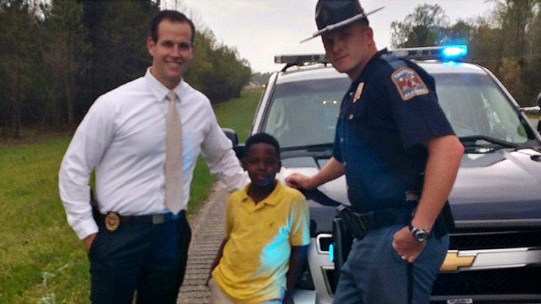 Ala. AG Investigator Eric Salvador, Christopher Wheeler, the young hero, and Trooper Lee Walls. (ALEA)