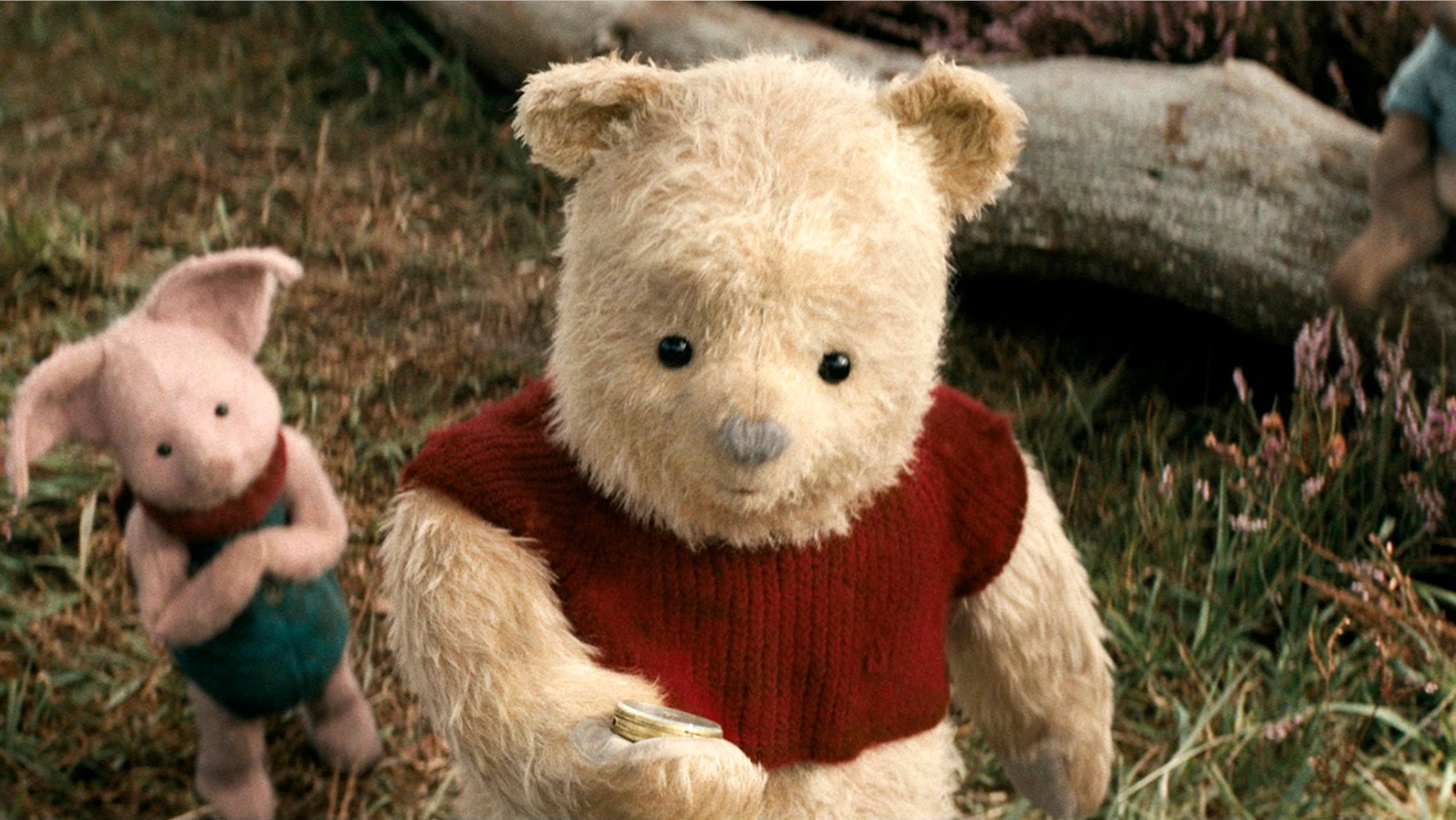 This image released by Disney shows characters Piglet, left, and Pooh in a scene from "Christopher Robin." (Laurie Sparham/Disney via AP)
