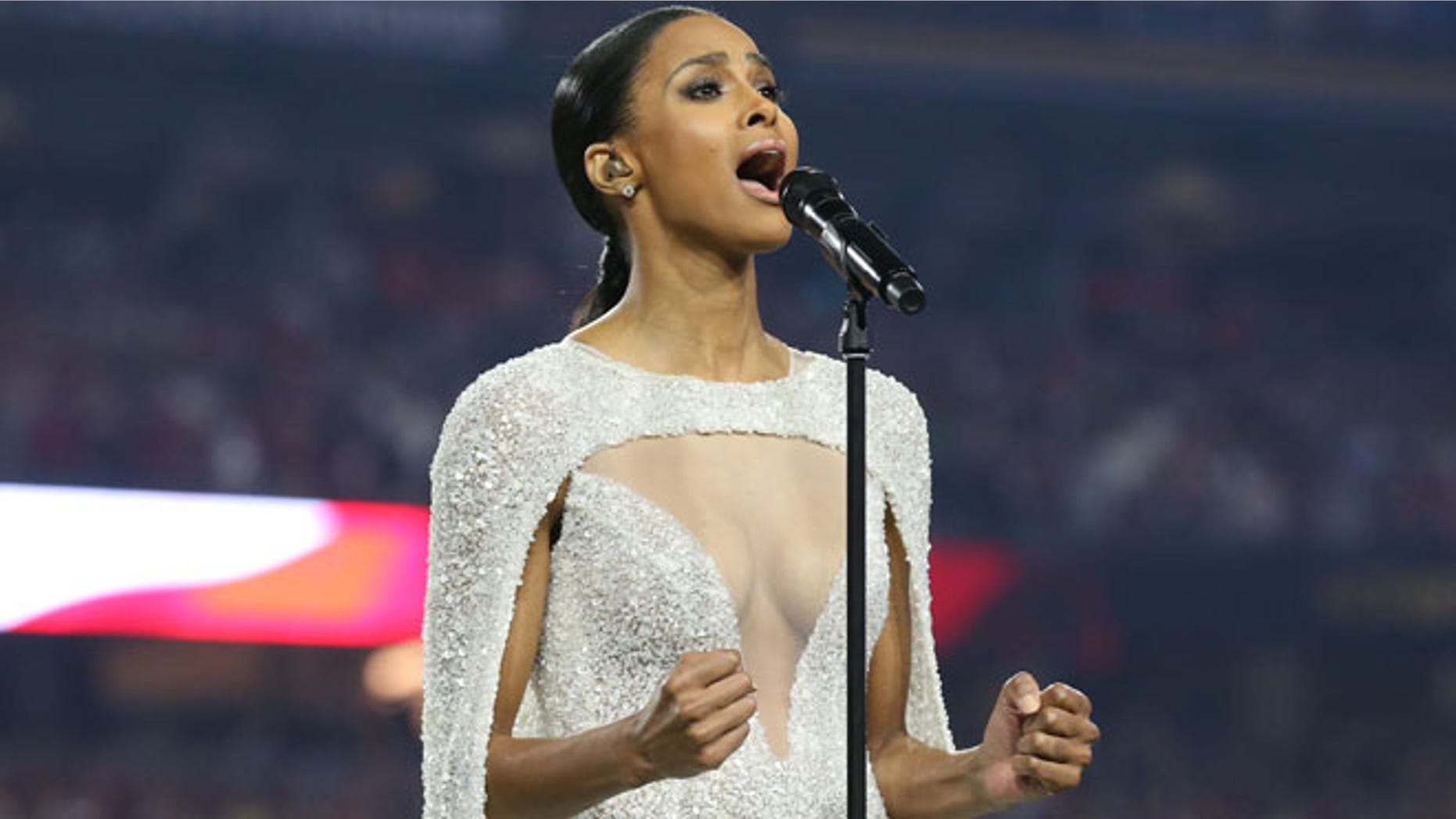 Jan 11, 2016; Glendale, AZ, USA; Recording artist Ciara sign the National Anthem prior to the game between the Alabama Crimson Tide and the Clemson Tigers in the 2016 CFP National Championship at University of Phoenix Stadium. Mandatory Credit: Matthew Emmons-USA TODAY Sports - RTX21XVG