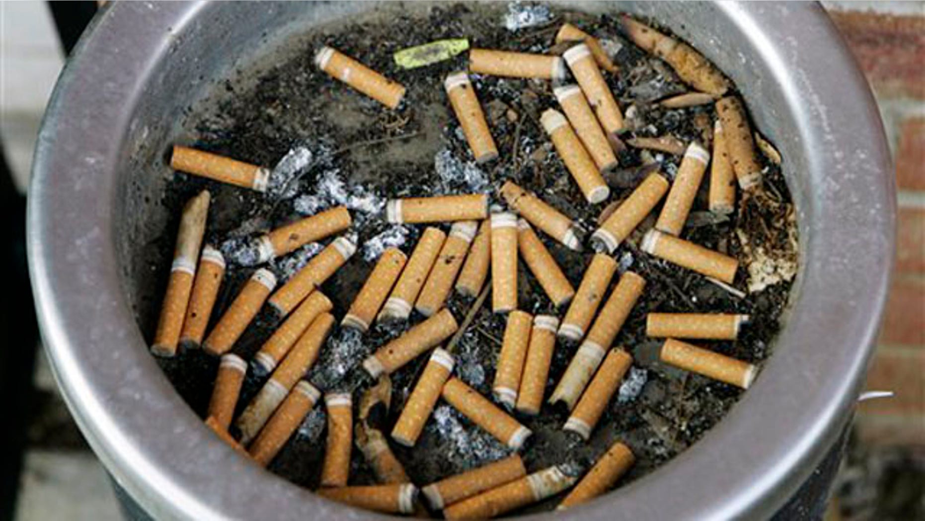 An ashtray full of cigarette butts is shown in Omaha, Neb., in this March 28, 2007, file photo.