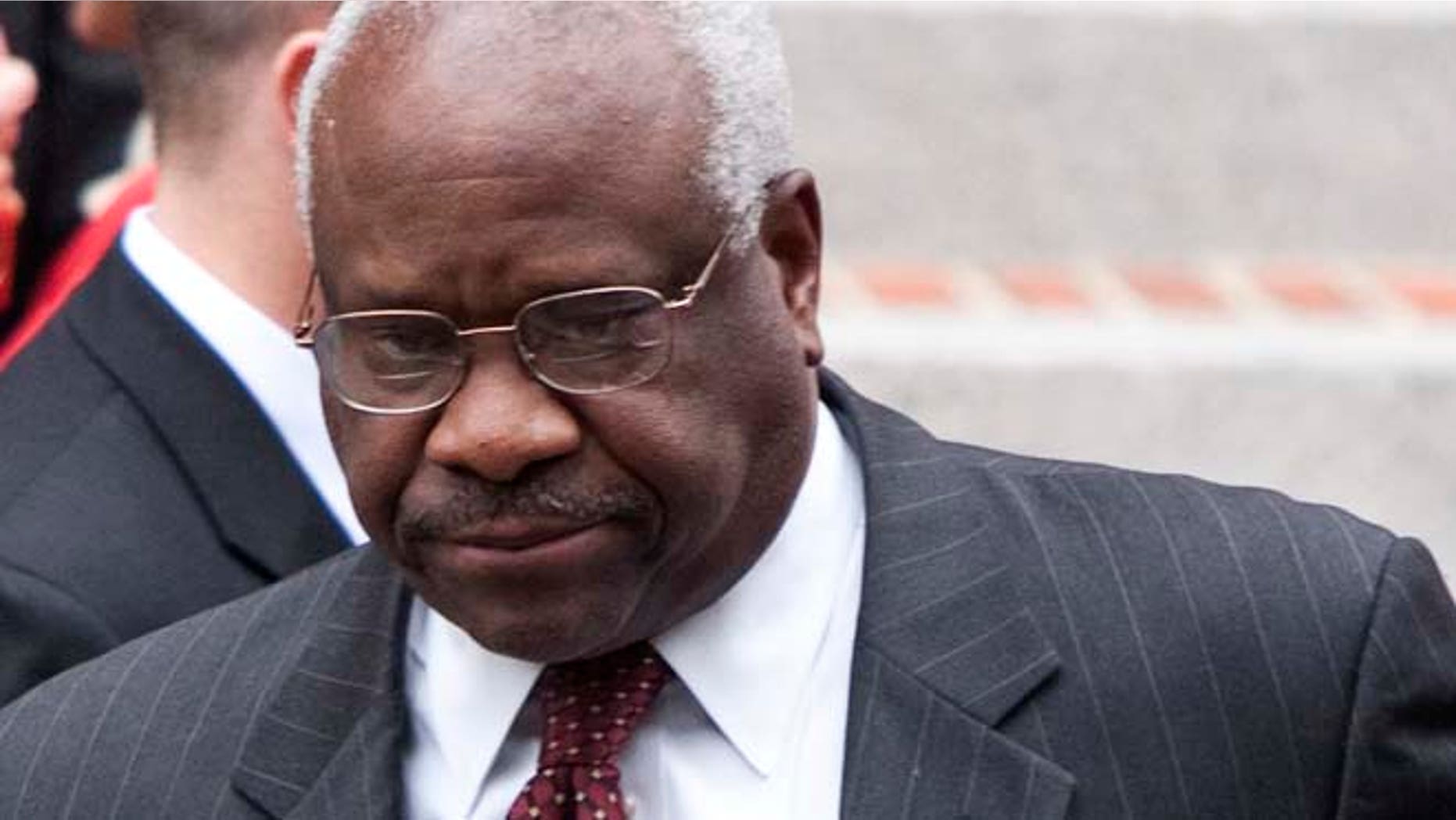 FILE 2011: A standardized-test textbook publisher apologized Tuesday for a graphic in a European History booklet that lumped Supreme Court Justice Clarence Thomas with the KKK.