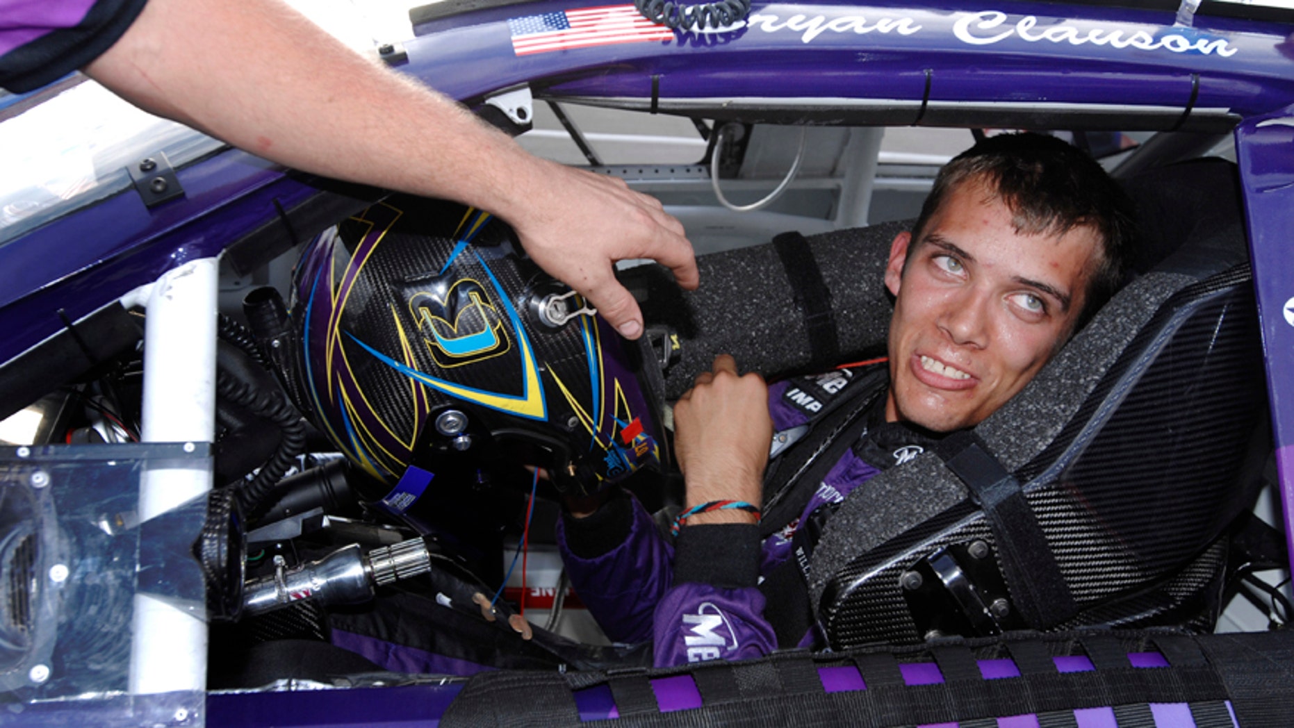 FILE - In this Oct. 4, 2007, file photo, Bryan Clauson smiles in his car during qualifying for the ARCA RE/MAX Series 250 auto race, at Talladega Superspeedway in Talladega, Ala. (AP Photo/Rainier Ehrhardt, File)