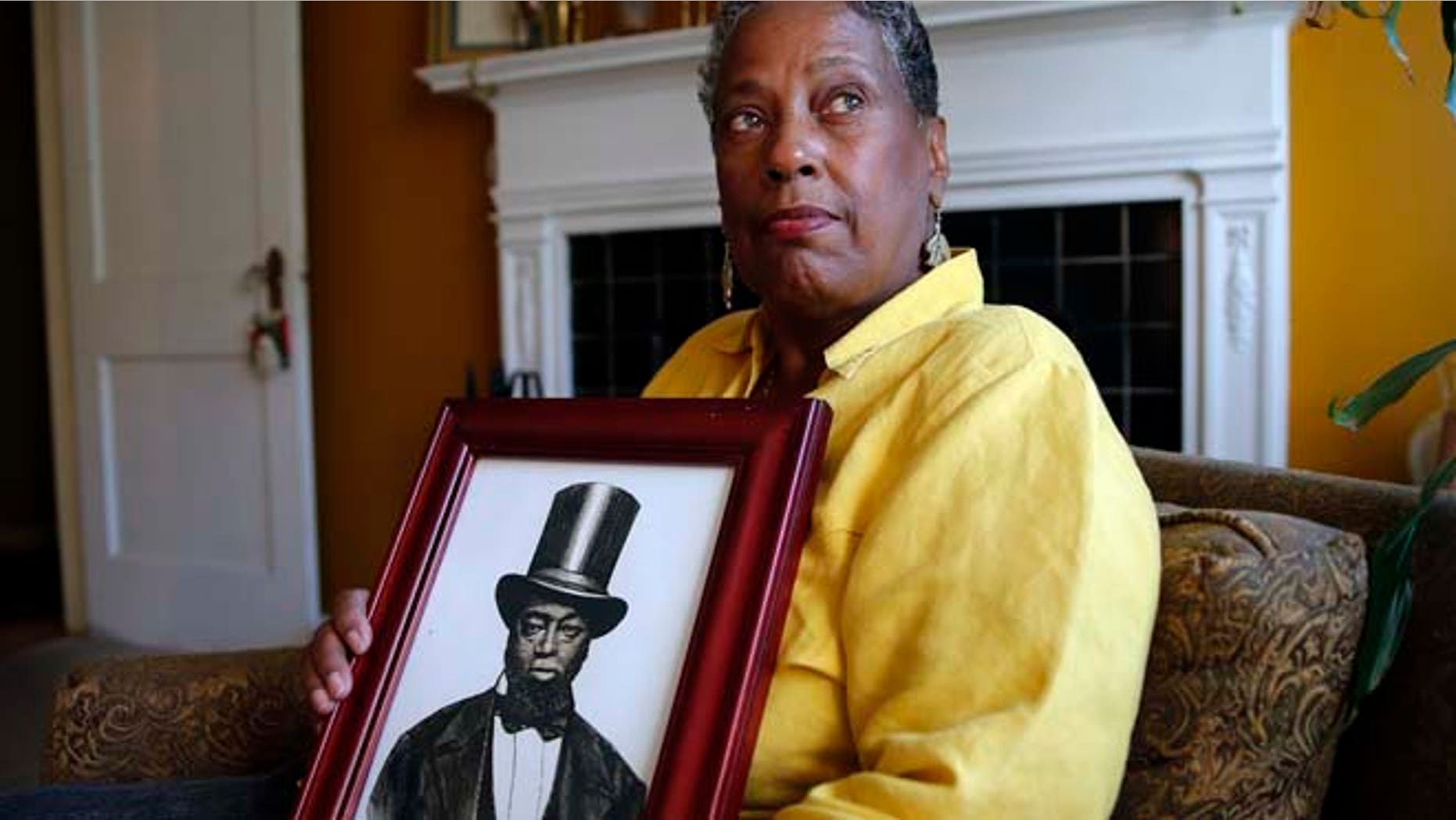 Oct. 20: Ocea Thomas poses for a portrait with a picture of her ancestor Samuel Burris that she received a phone call this weekend letting her know that Gov. Jack Markell would pardon Burris, a free black man and conductor on the Underground Railroad who died in 1863.